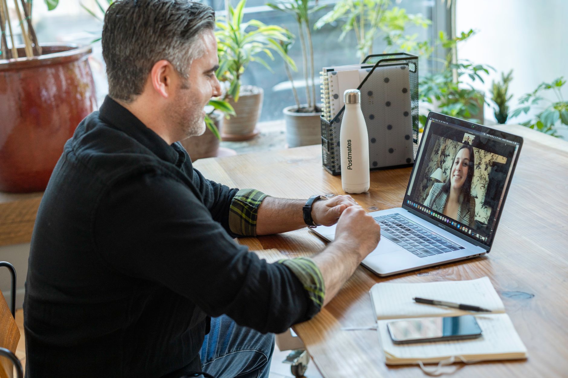 A man engages in a remote video call with a dietitian on his laptop, showcasing telemedicine convenience.