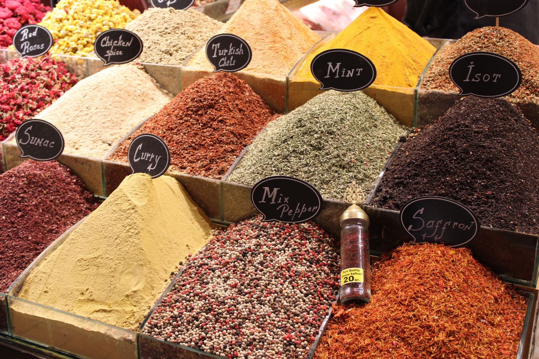 Colorful spices including saffron and curry displayed in a Turkish market.
