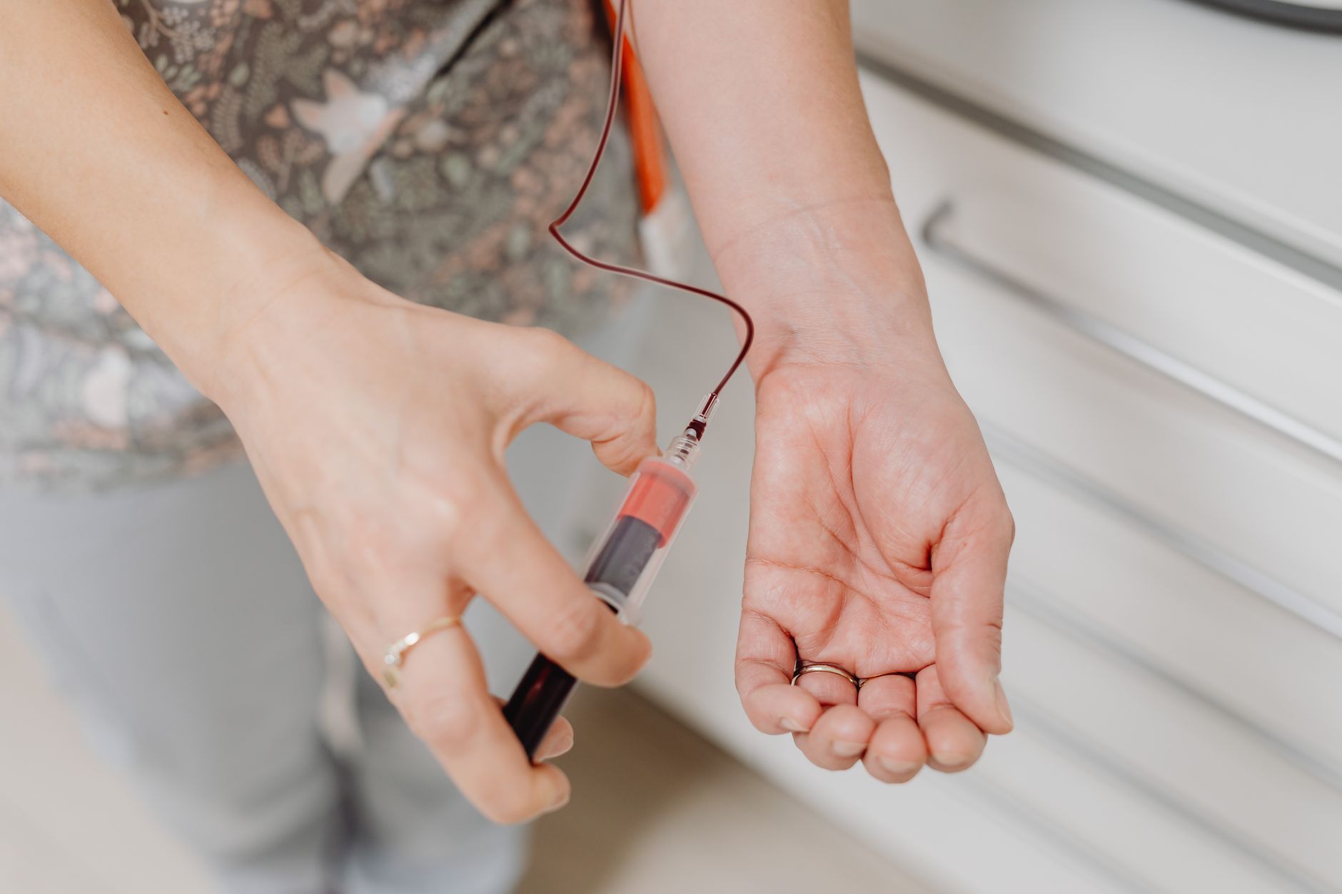Close-up of a nurse locating a vein for IV insertion with ultrasound guidance.