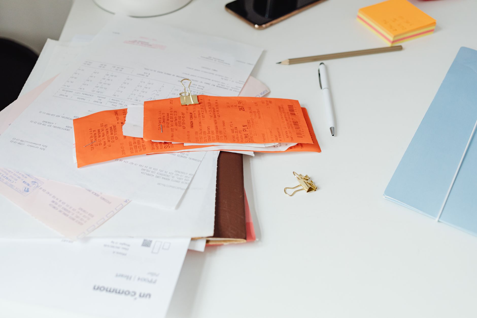 Close-up of various documents and invoices on a desk, depicting hospital billing.
