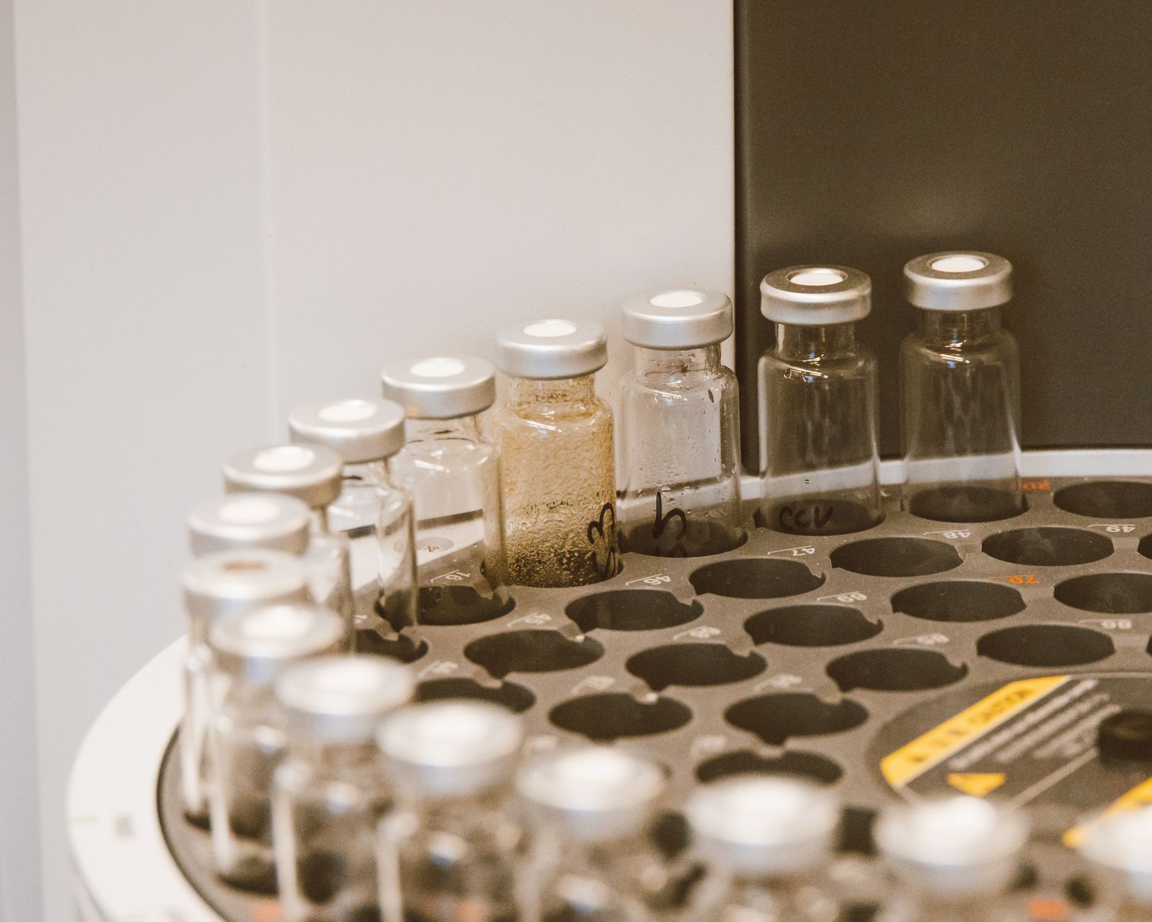 Close-up of laboratory vials used in genomic sequencing and molecular diagnostics on a rack.