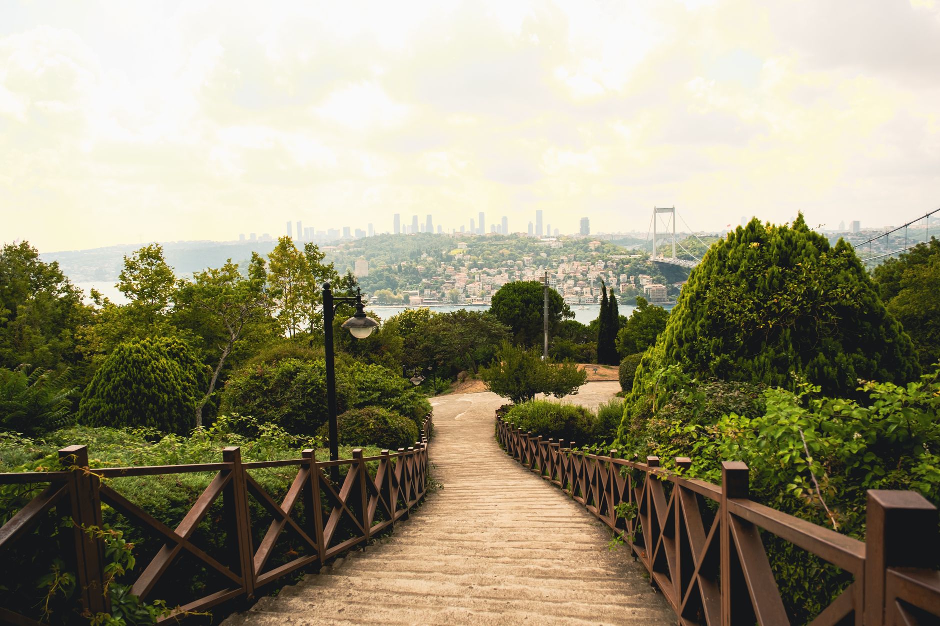Pathway leading down to the Bosphorus with greenery and city view in Istanbul.