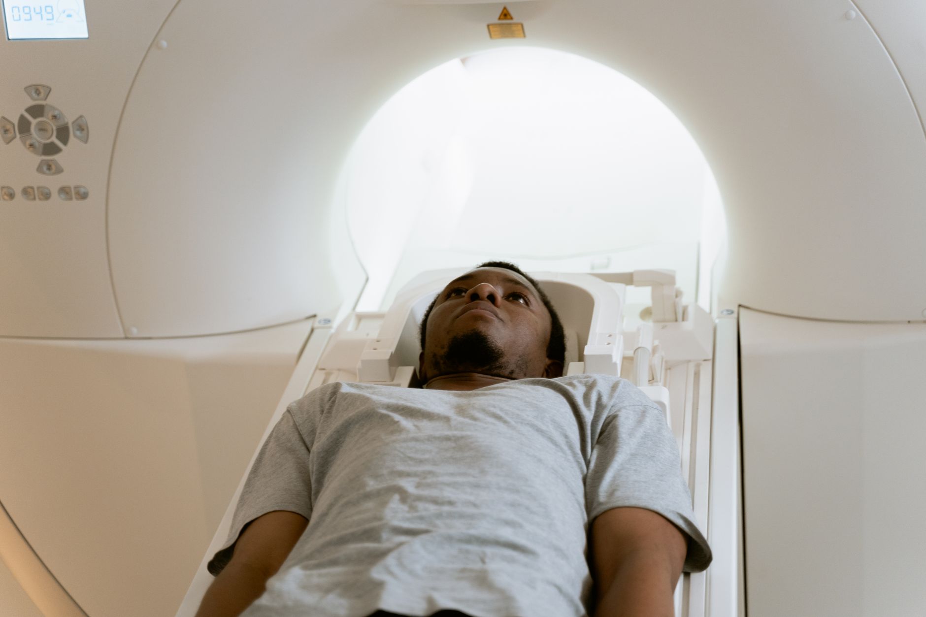 A patient lying in a CT scanner, ready for a low-radiation imaging procedure.