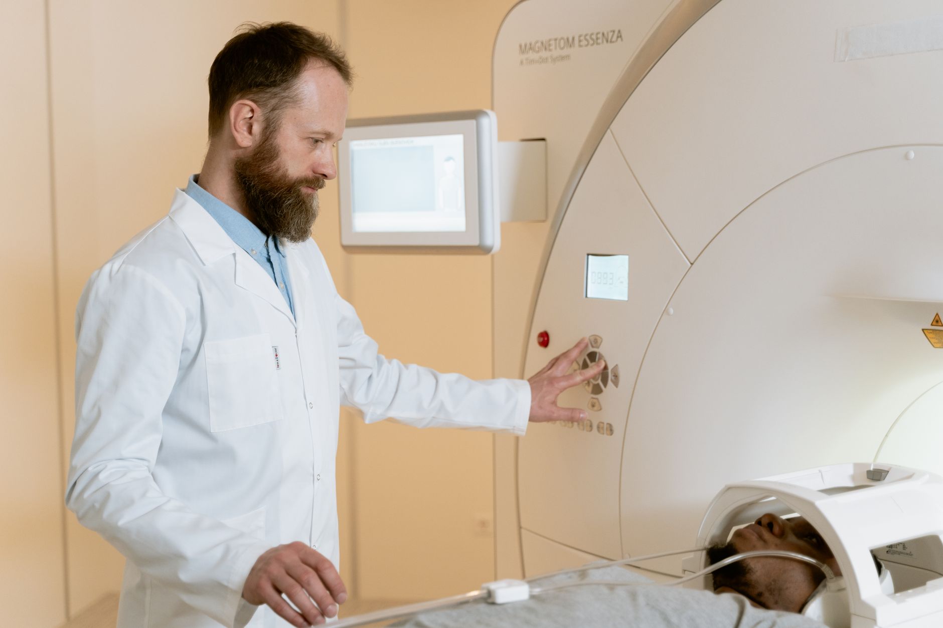 A doctor operates an MRI machine while a patient lies inside it in a Turkish hospital.