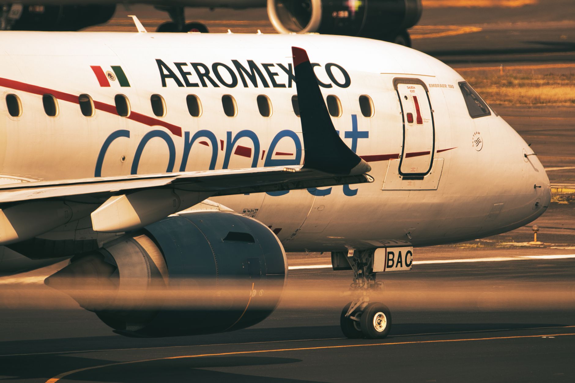 Aeromexico Connect plane taxiing on runway, showcasing airline branding.