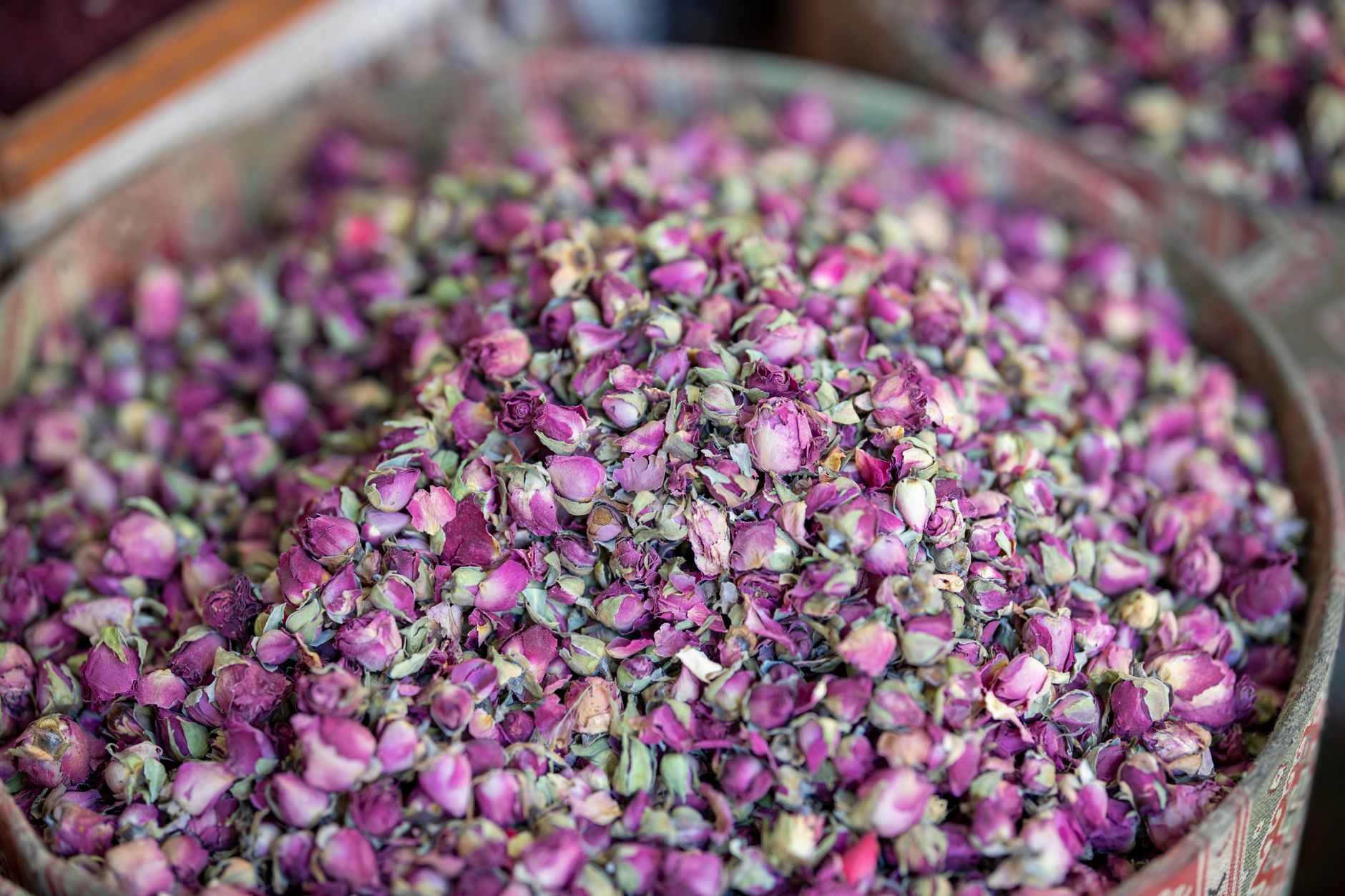 Vibrant pile of dried rose petals in a traditional market in Isparta.