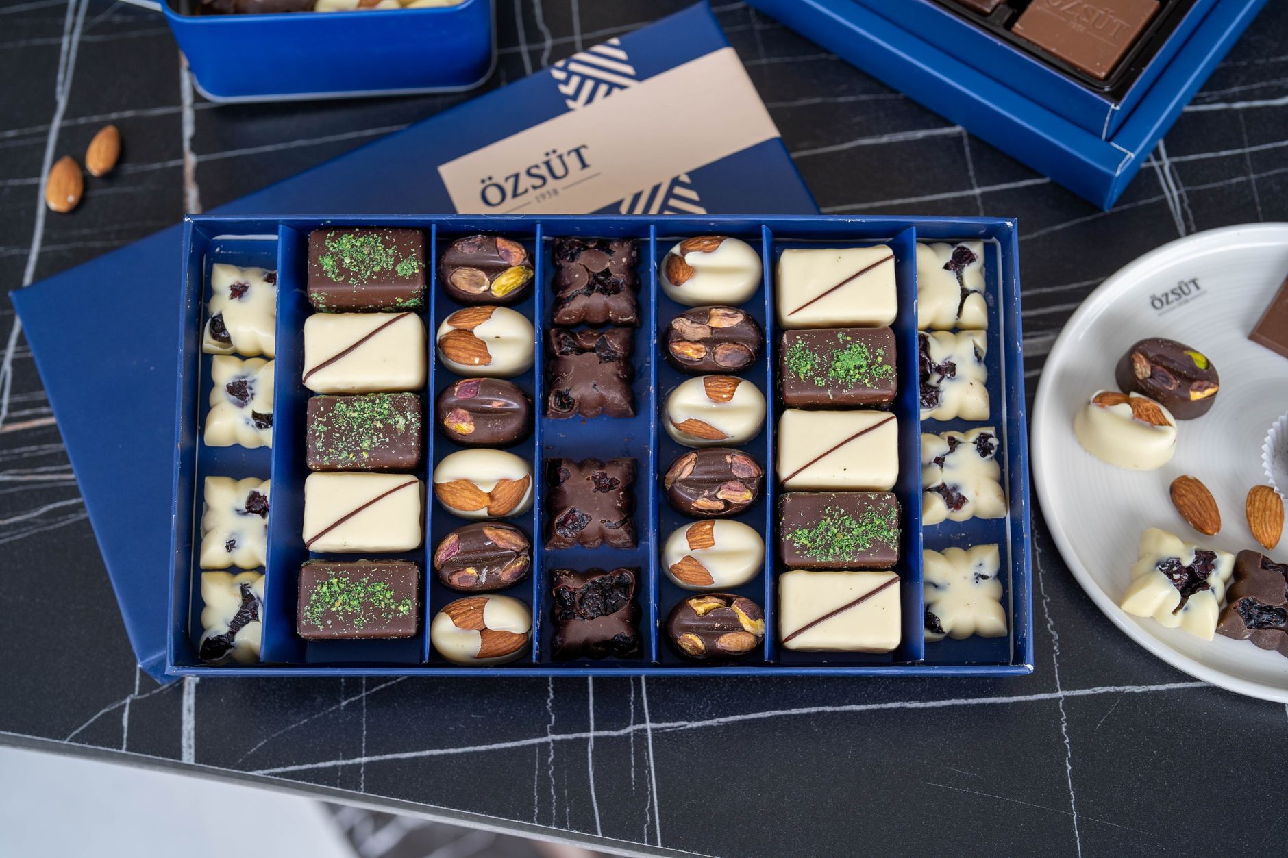 A beautifully arranged box of artisan Turkish pralines featuring flavors like pistachio and rose.