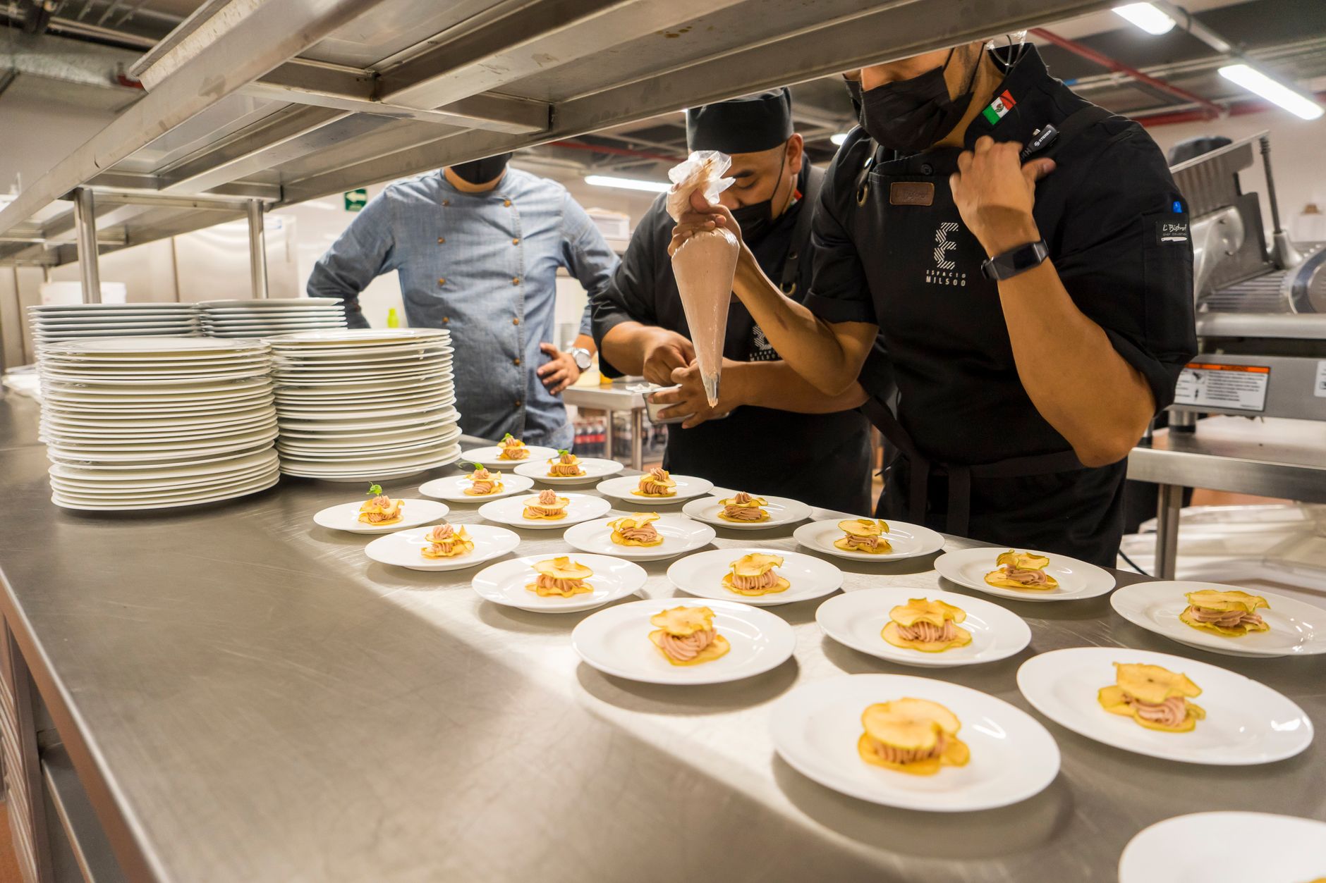 Chefs work in a hospital kitchen, plating allergen-free dishes with precision.