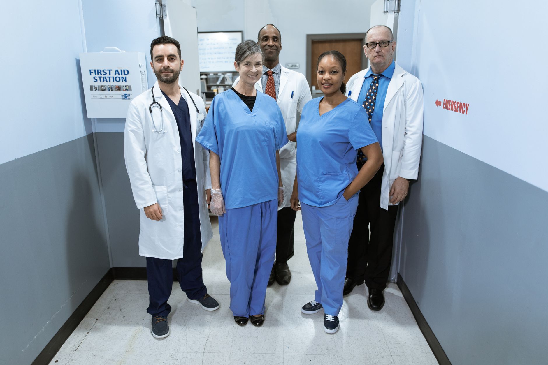 A diverse group of healthcare professionals in a first aid station, ready to assist patients.