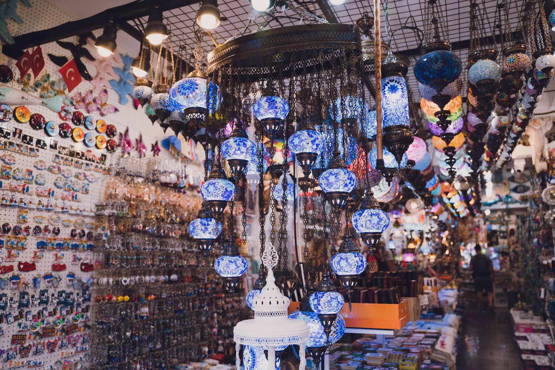 Interior of a Bodrum bazaar featuring colorful lanterns and local crafts.