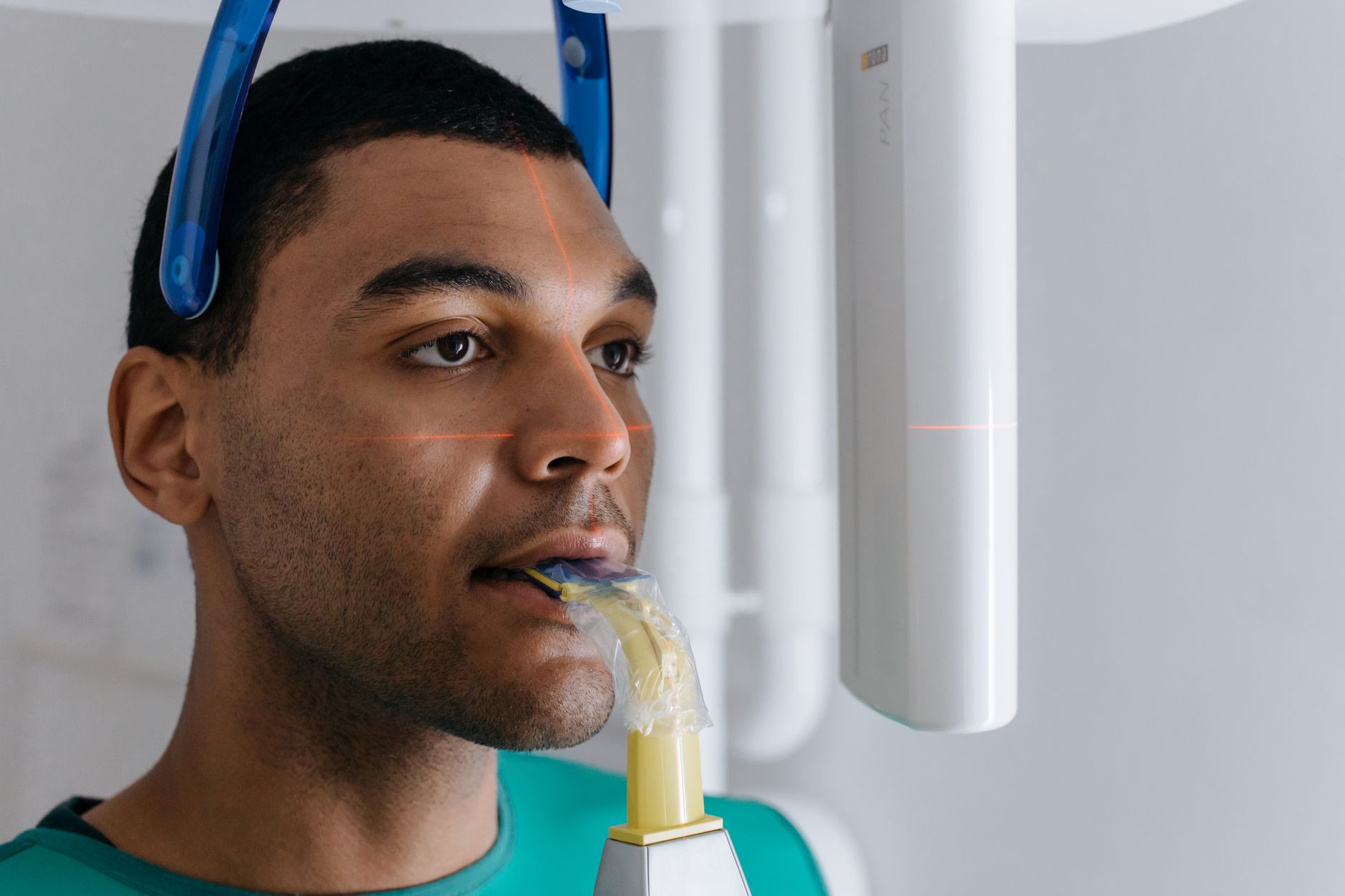 Patient undergoing intraoral scanning with a digital device in a dental clinic.