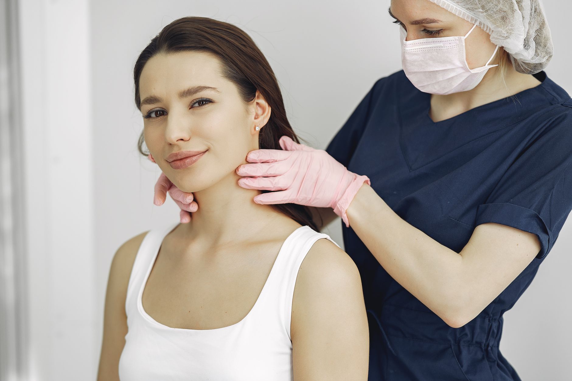 Close-up of a dermatologist examining a patient's skin with a digital dermoscope.