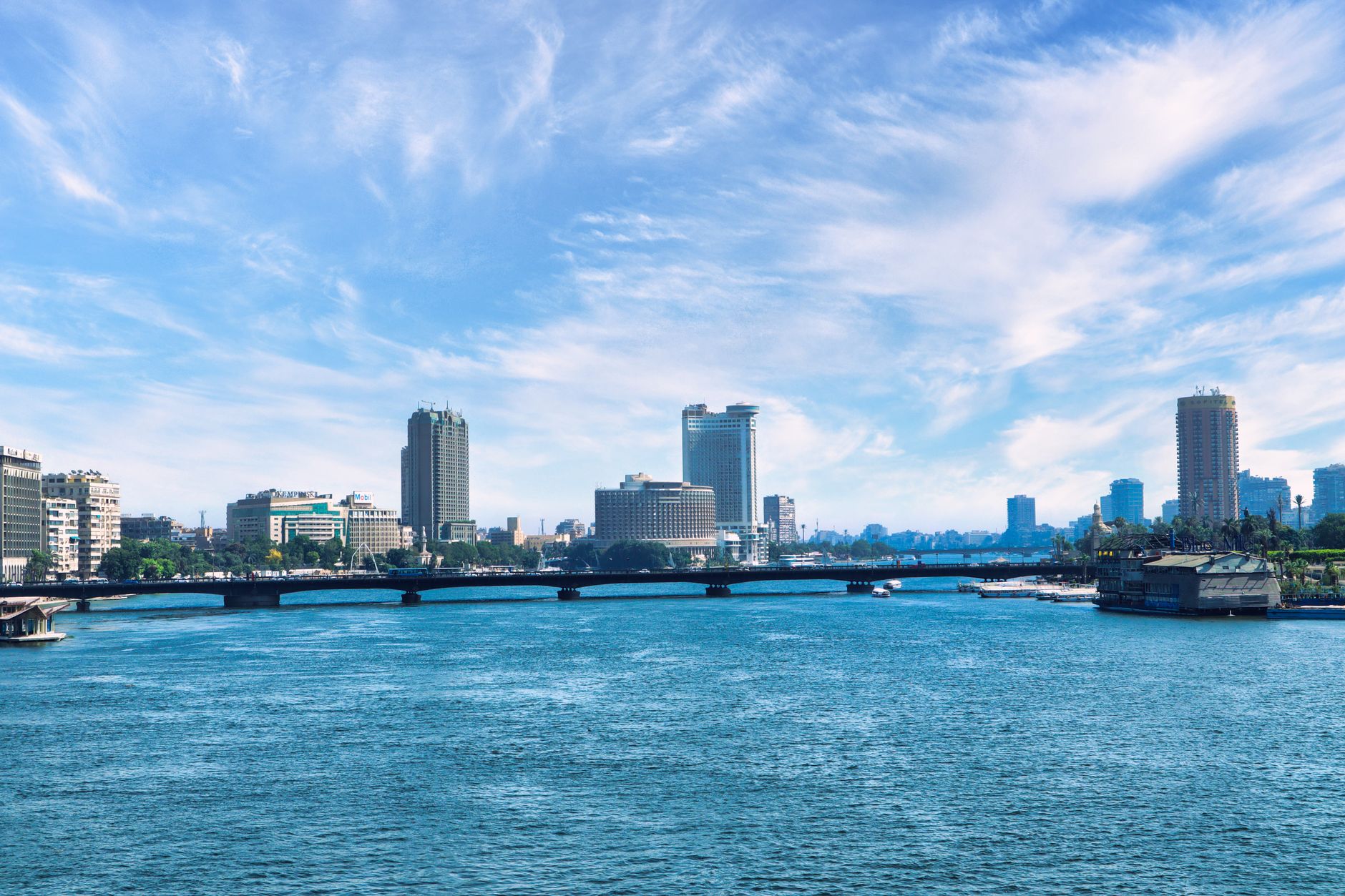 A view of Cairo's skyline with a modern medical facility by the Nile River.