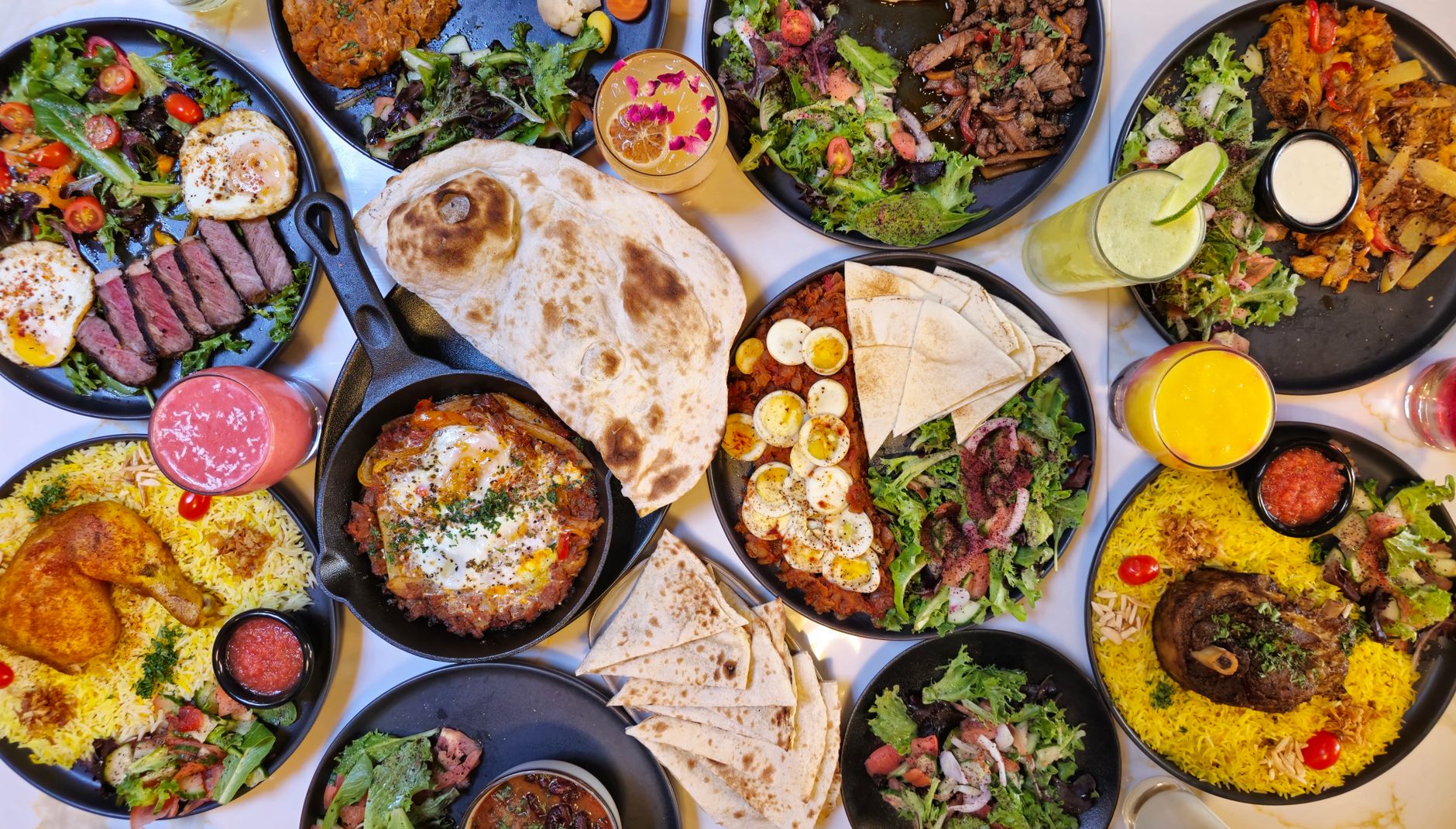 An array of Halal dishes including grilled meats, salads, and rice served at a restaurant in Istanbul.
