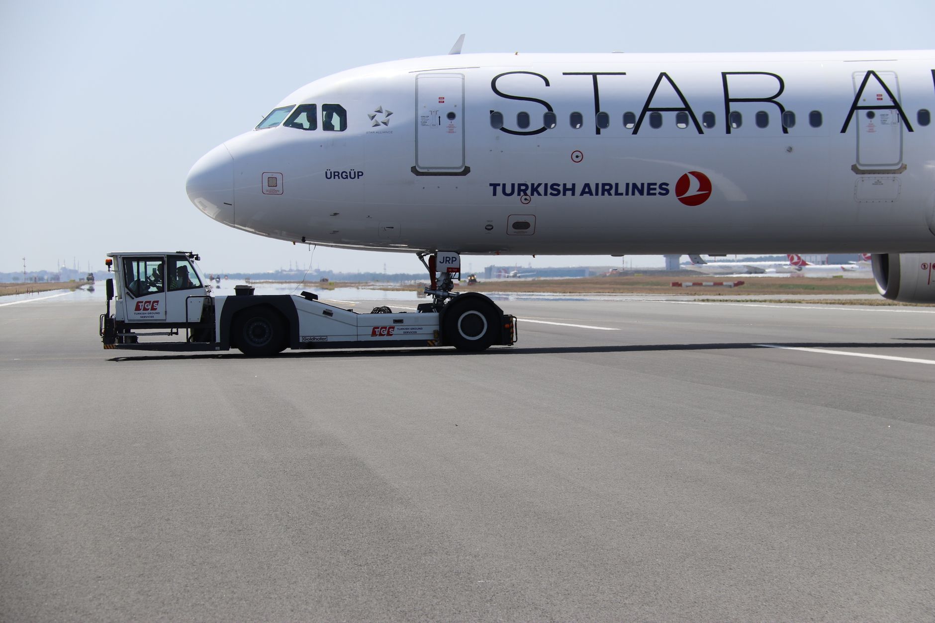 A Turkish Airlines plane being towed on the tarmac at Istanbul Airport.