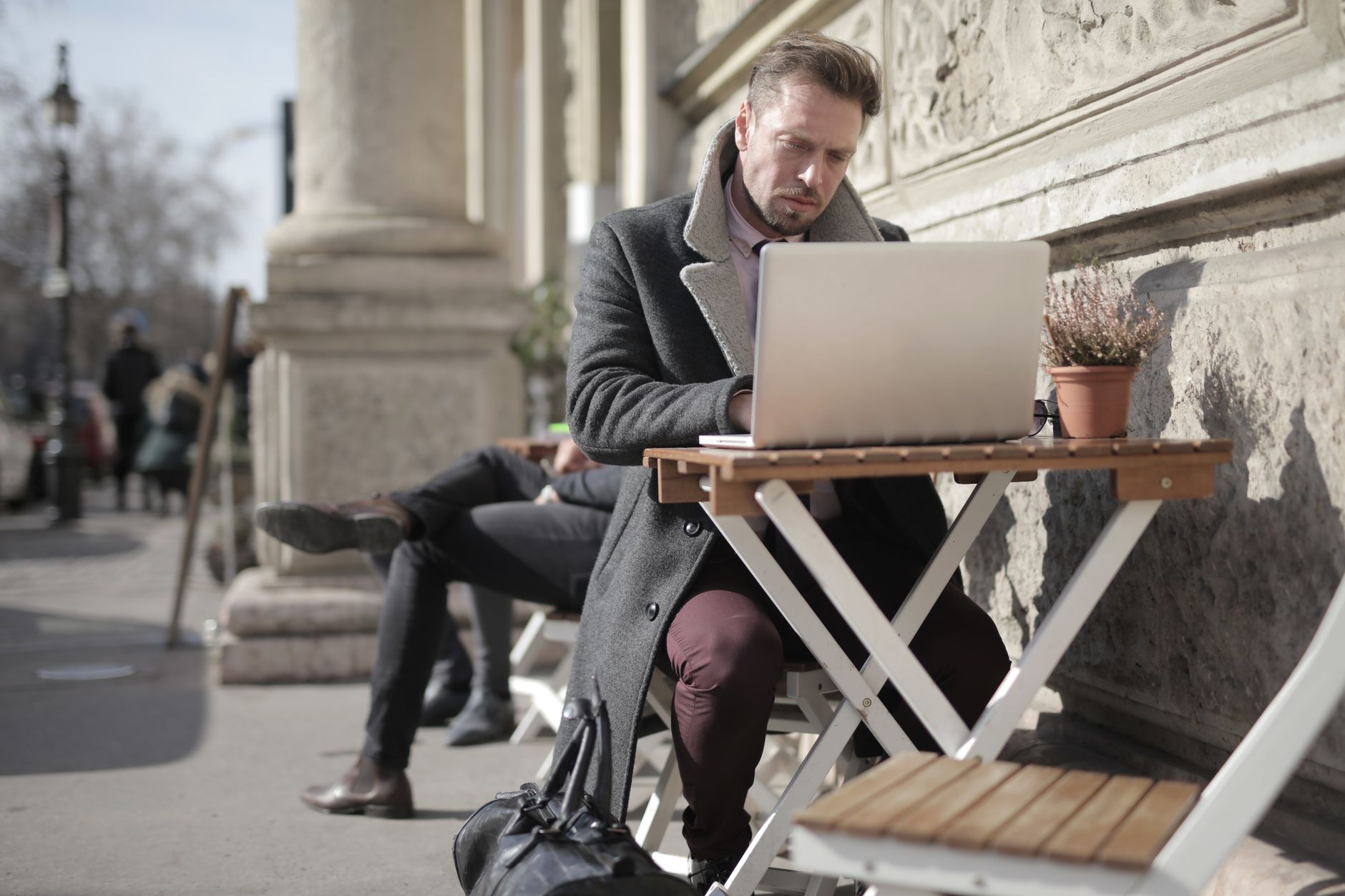 A man working on a laptop at a cafe in Turkey, showcasing remote work culture.