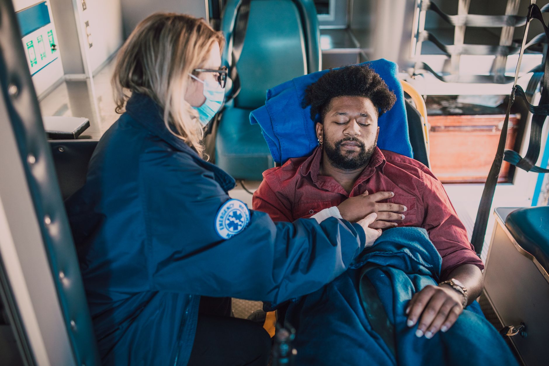 Interior of a medical air ambulance, featuring a patient receiving care from a EMT.