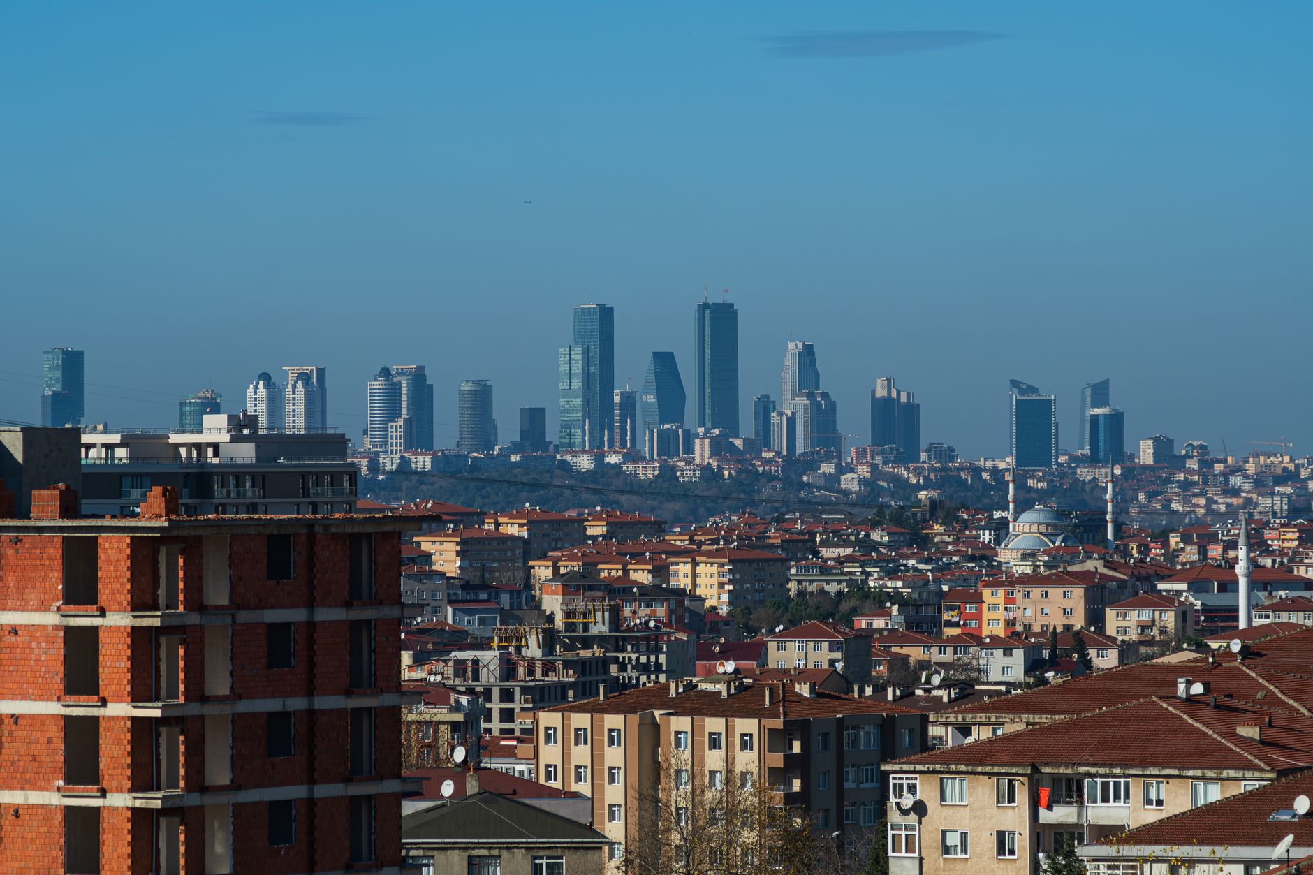 A panoramic view of Istanbul's skyline featuring modern skyscrapers and residential buildings.