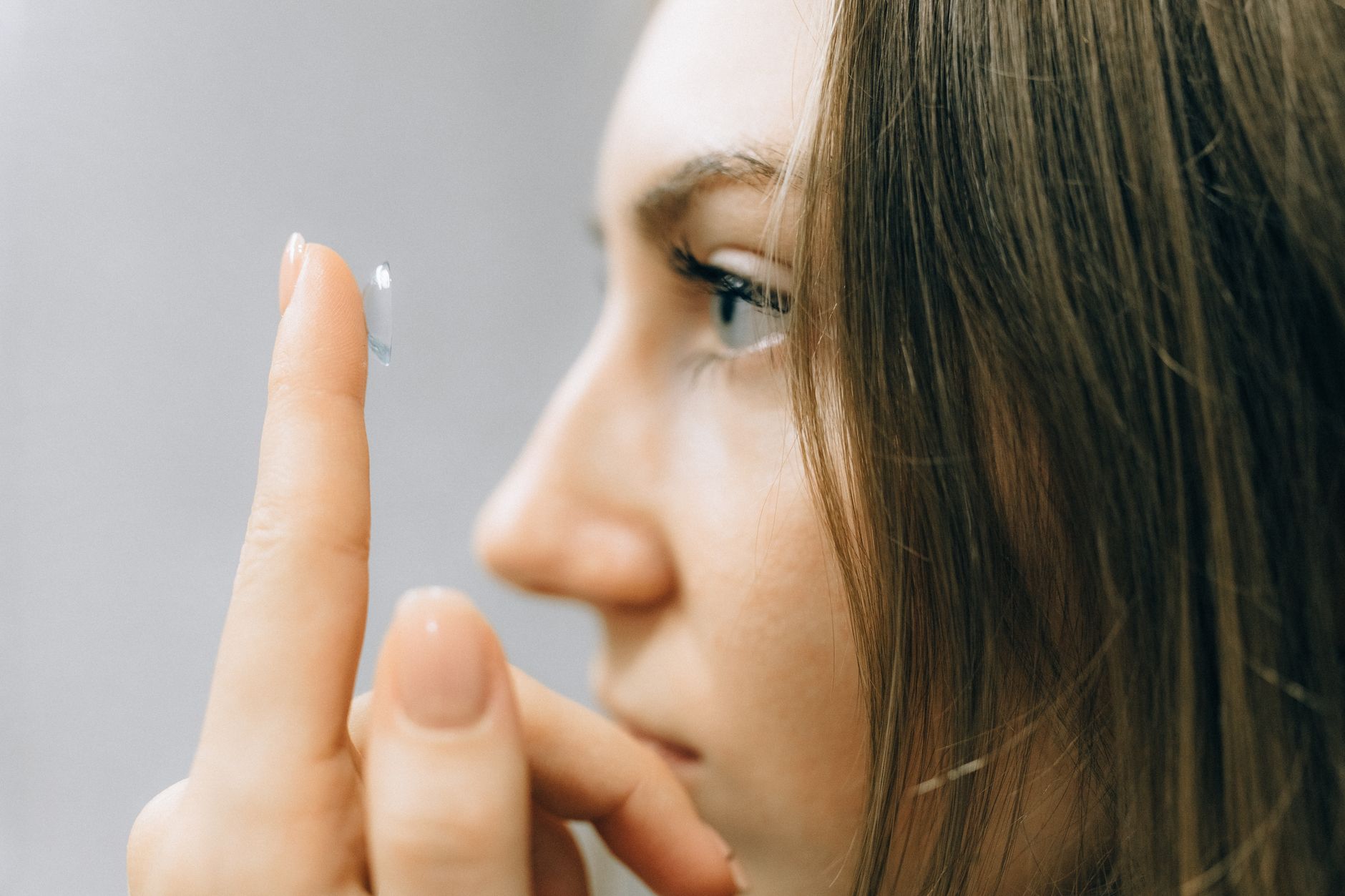 Close-up of a person preparing to insert a large scleral lens.