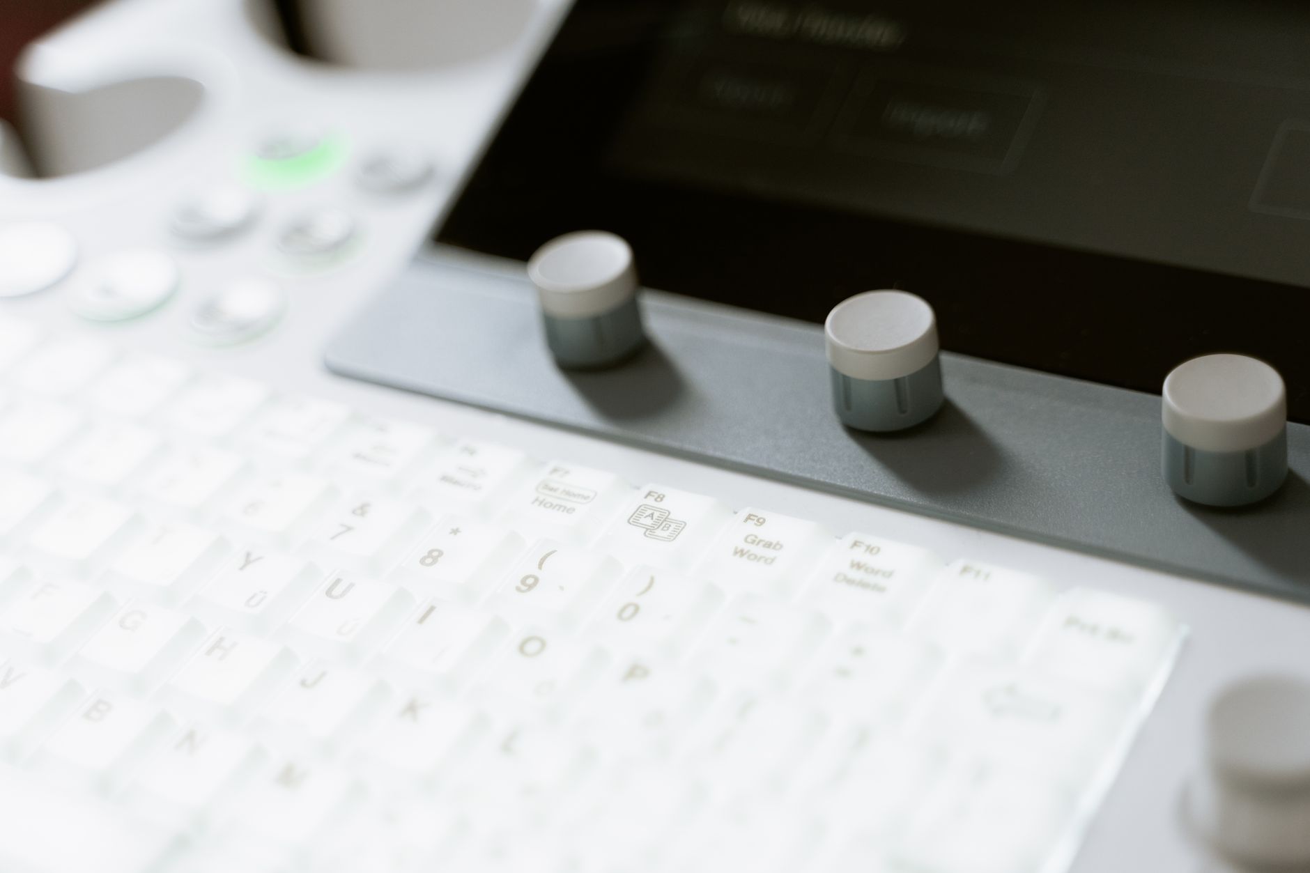 Close-up of a kidney ultrasound machine's controls and keyboard.