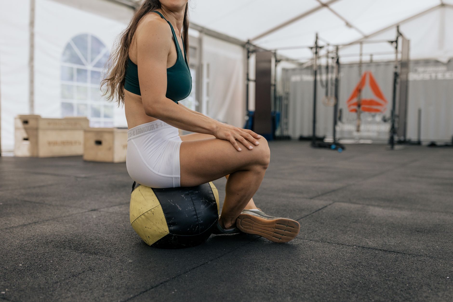 A patient in a compression garment gently walks in a gym, showcasing early recovery post-surgery.