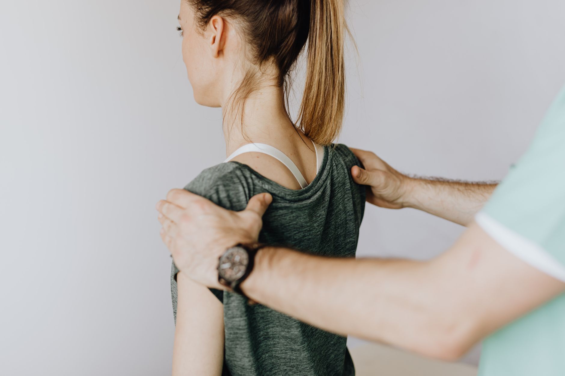 A physiotherapist assists a patient with core stability exercises after spine surgery.