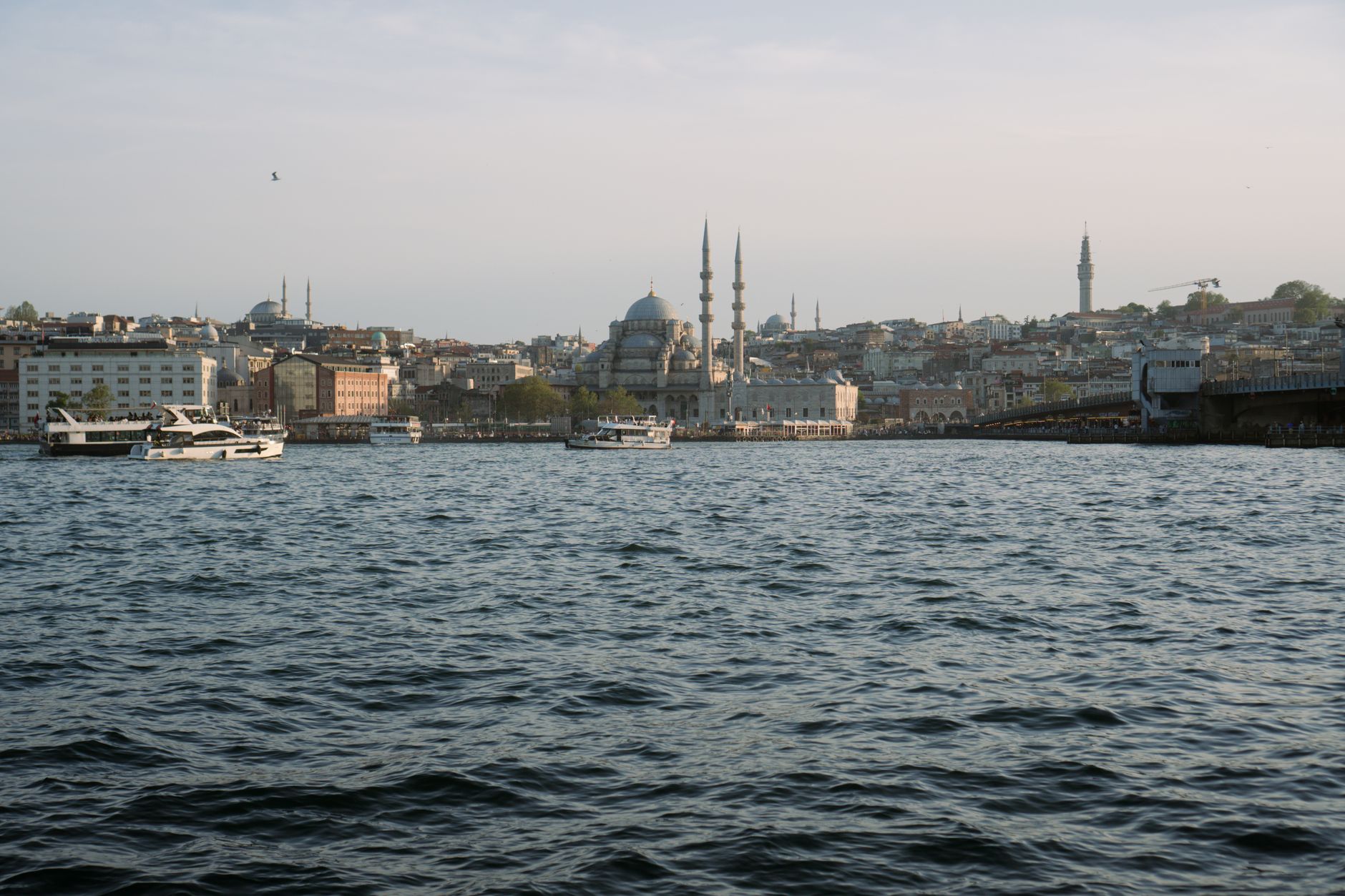 A picturesque view of Istanbul's skyline with minarets and boats on the Bosphorus.
