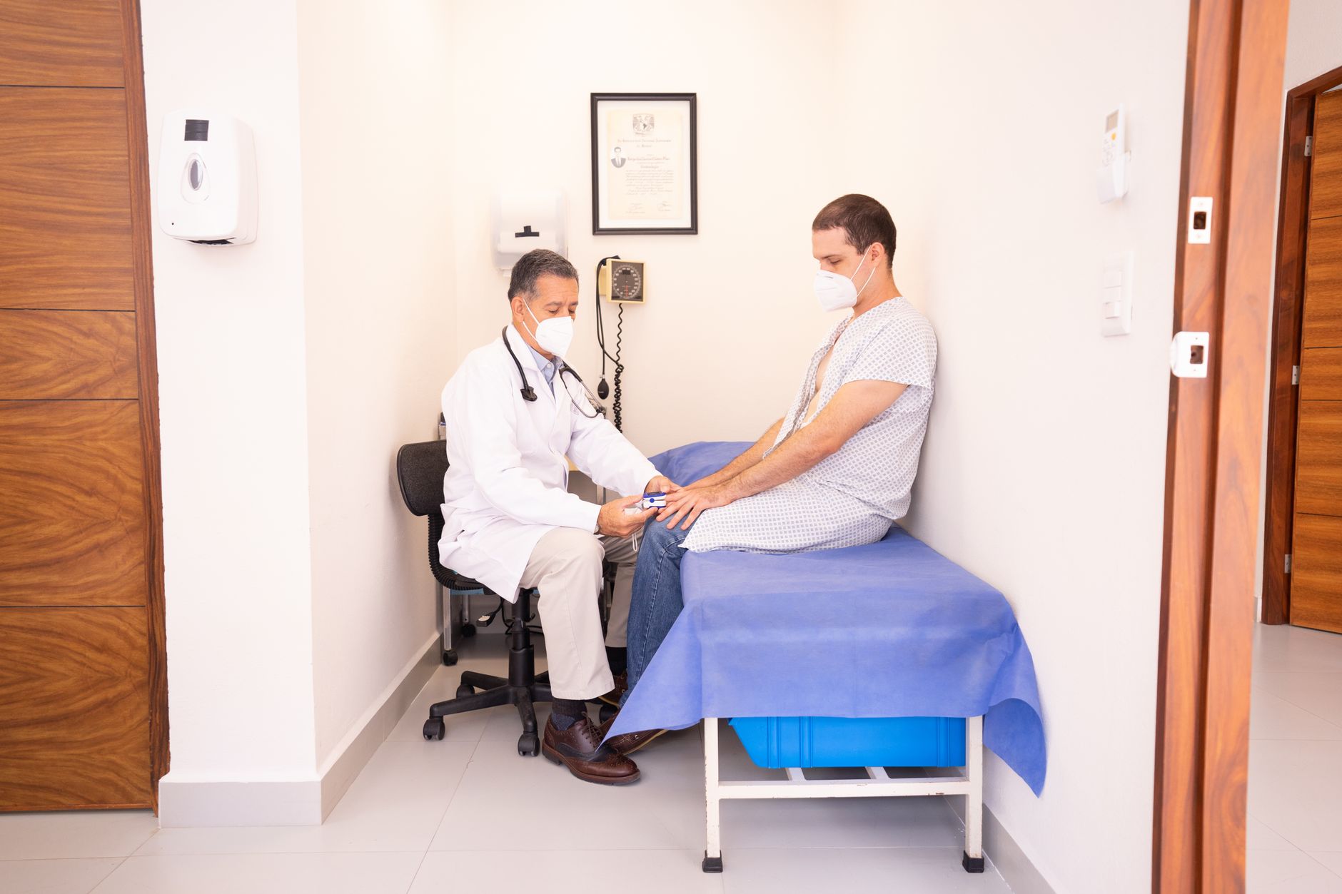 A healthcare professional examining a patient in a hospital room in Turkey.