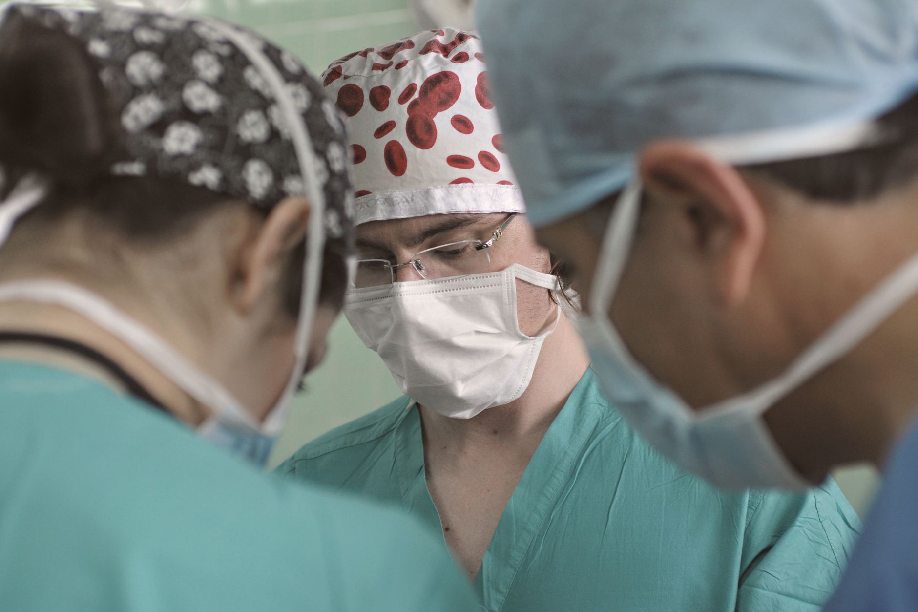Close-up of a Turkish surgical team focused on a patient during an advanced procedure.