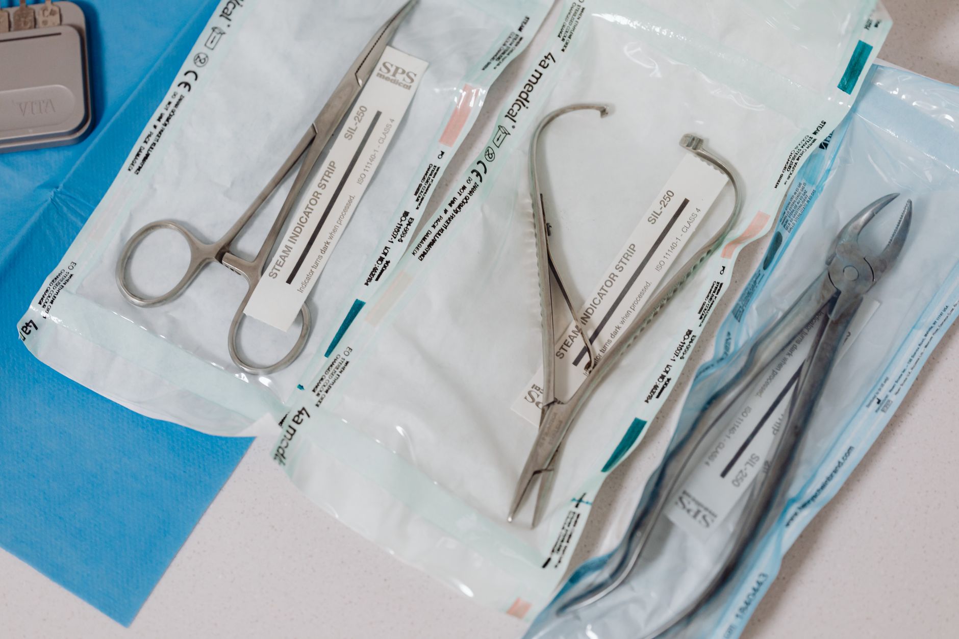 Close-up of sterilized surgical instruments in packets, prepared for a live demonstration.