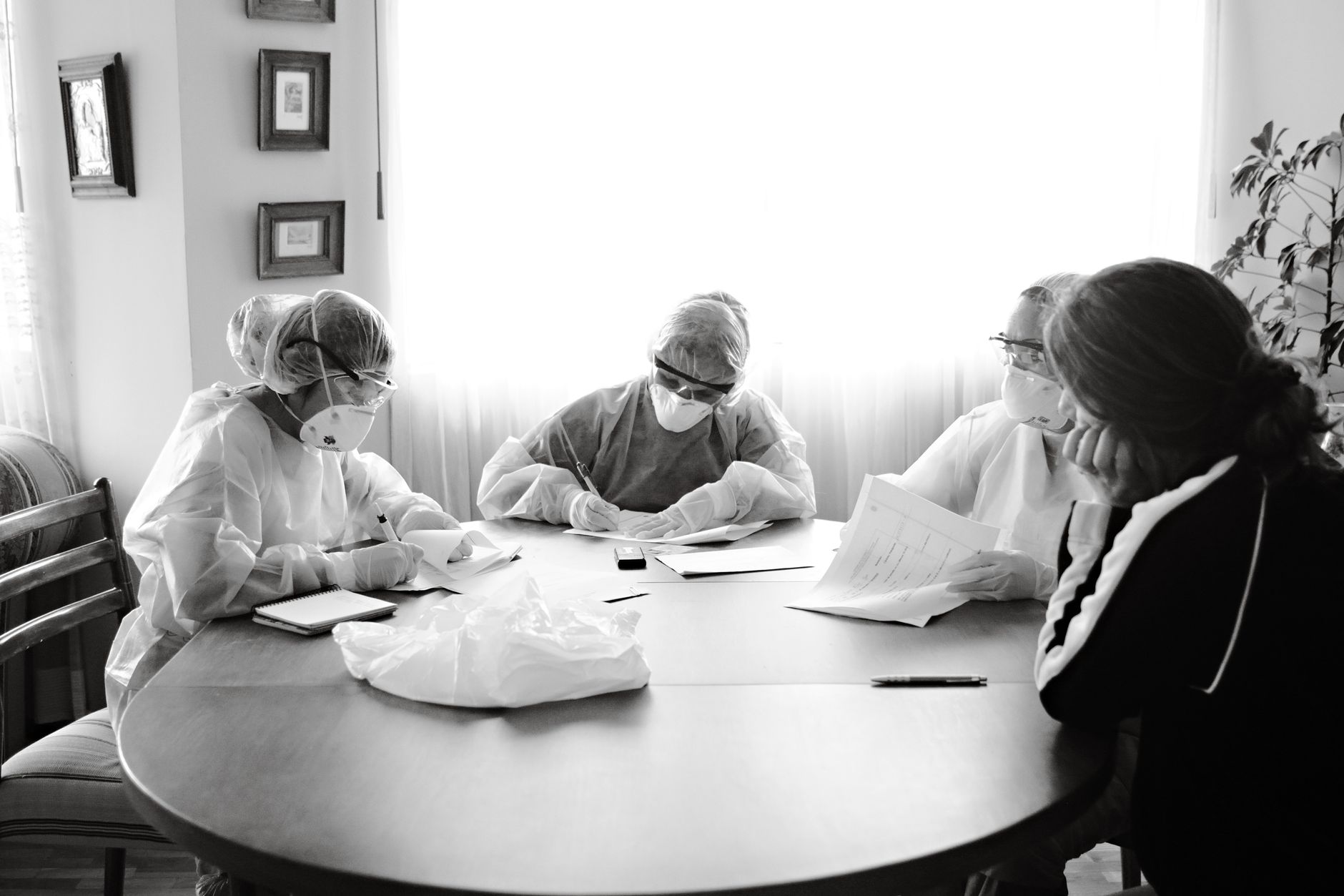 Medical team wearing protective gear collaborating at a table in Istanbul.