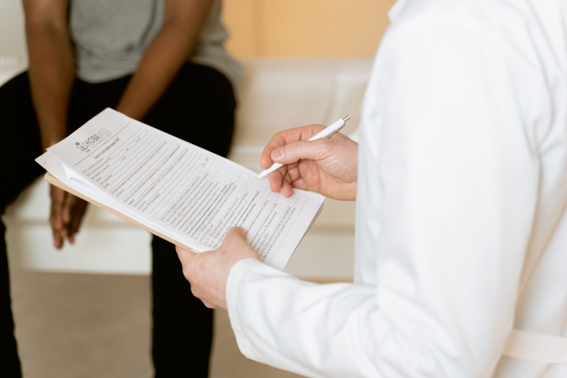 A healthcare professional explains a discharge summary to a patient, ensuring clear communication.