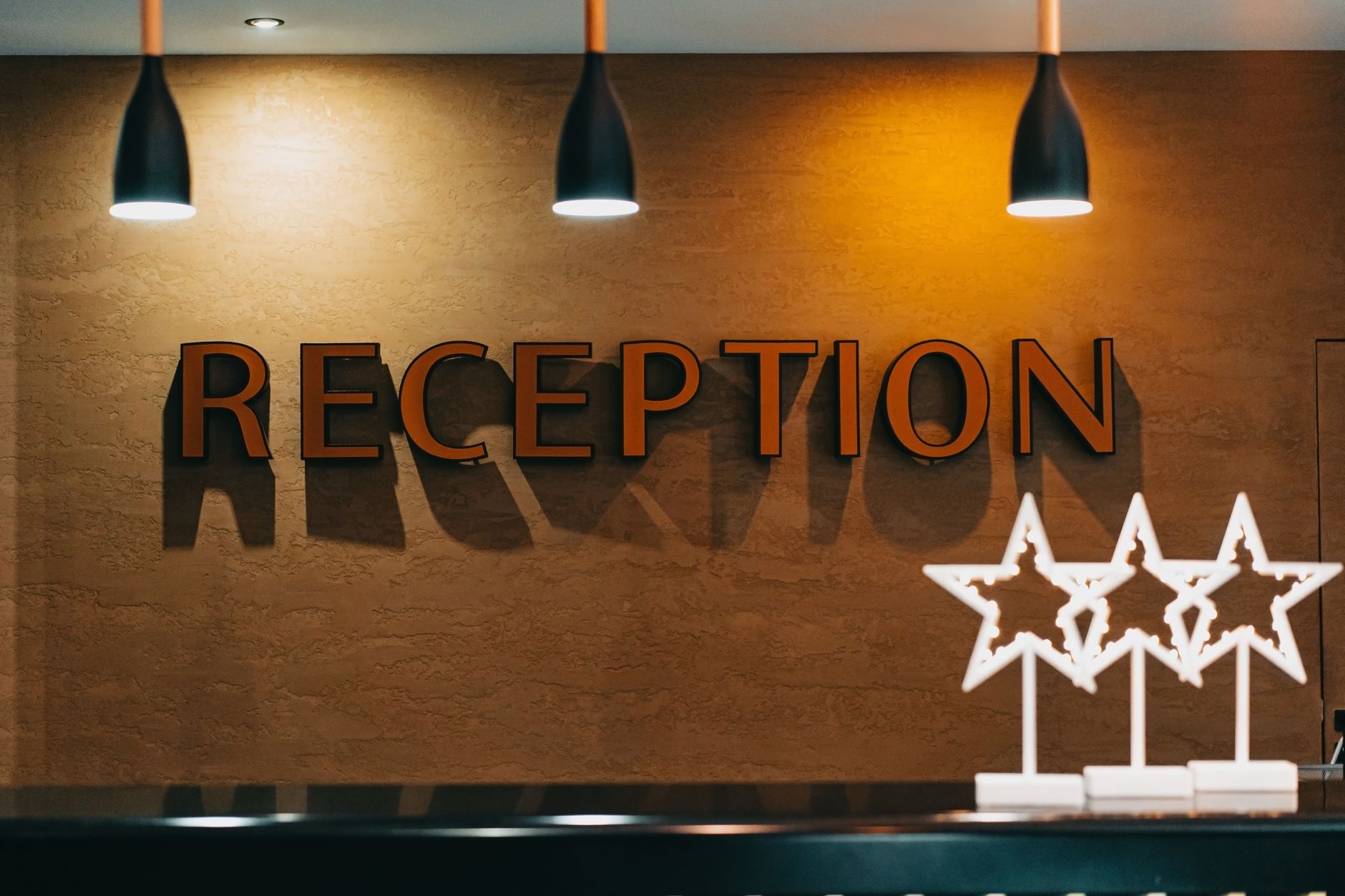 Hospital reception area in Istanbul featuring a warm design and multilingual signage.