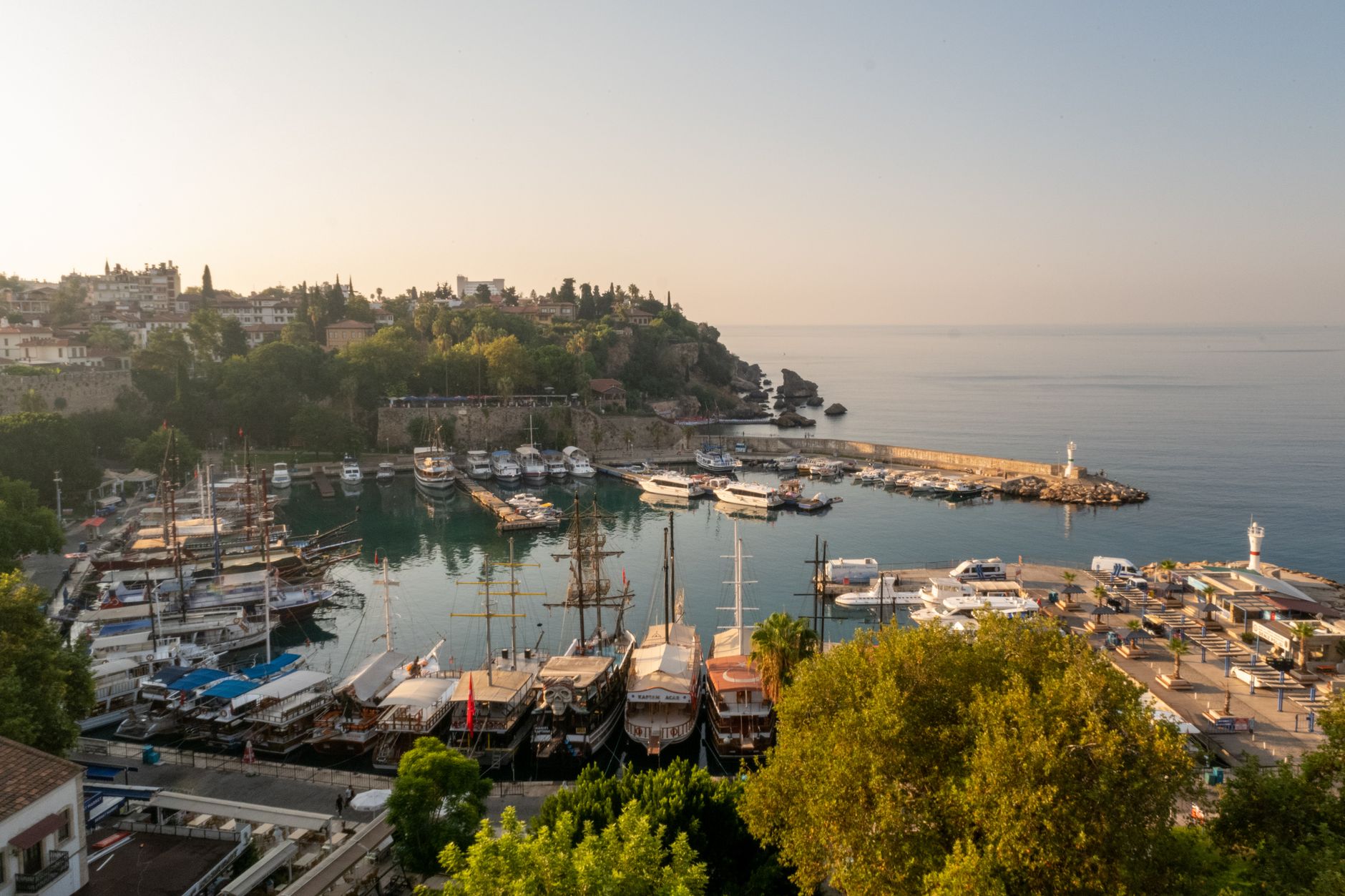 A serene aerial view of Antalya marina showcasing boats and lush coastline, ideal for medical travel and relaxation.