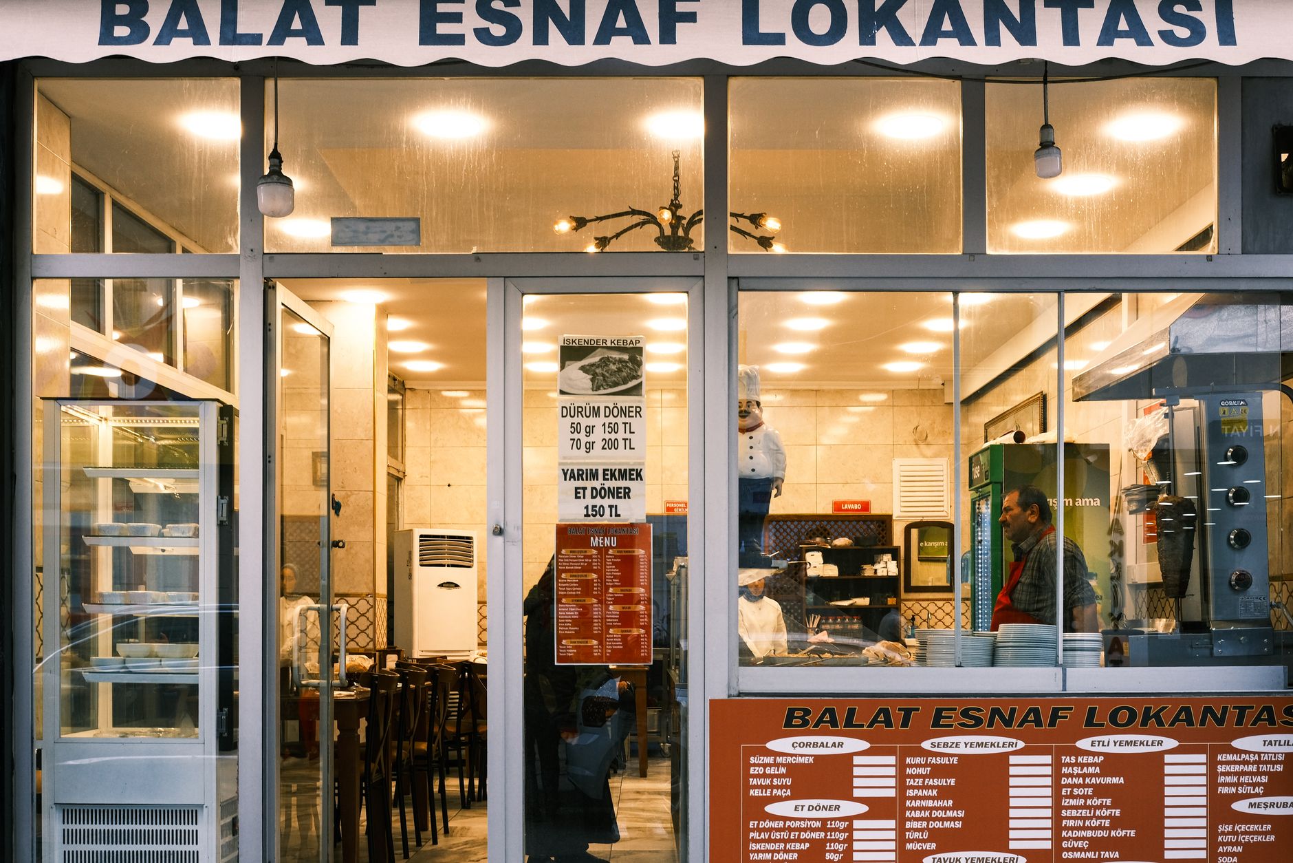 Exterior view of Balat Esnaf Lokantası in Istanbul, showcasing a warm dining atmosphere.