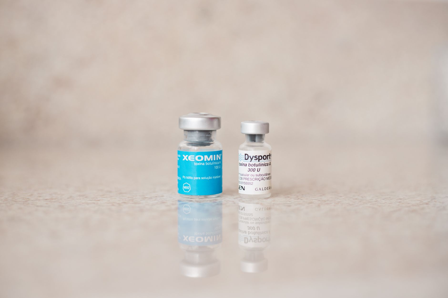 Two vials of botulinum toxin: Xeomin and Dysport, used in migraine therapy.