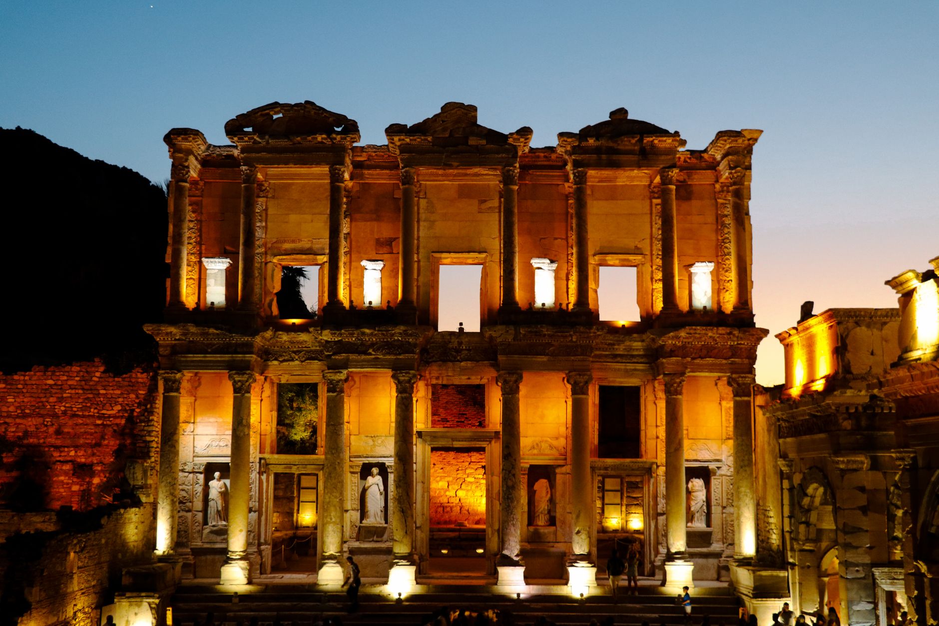 Celsus Library ruins lit up at night in Selçuk, Ephesus, offering a stunning view.