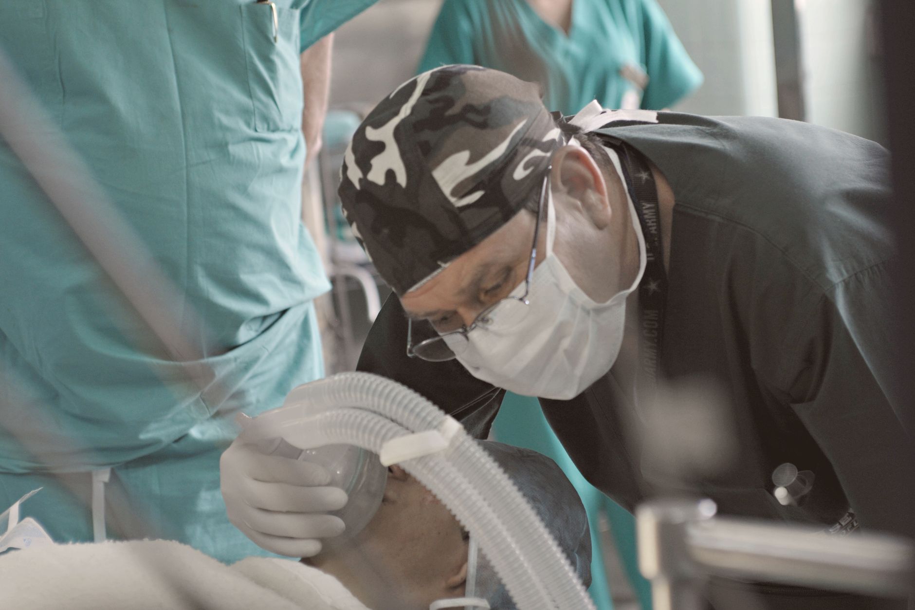 An anaesthesiologist closely monitors a patient's vitals during surgery.