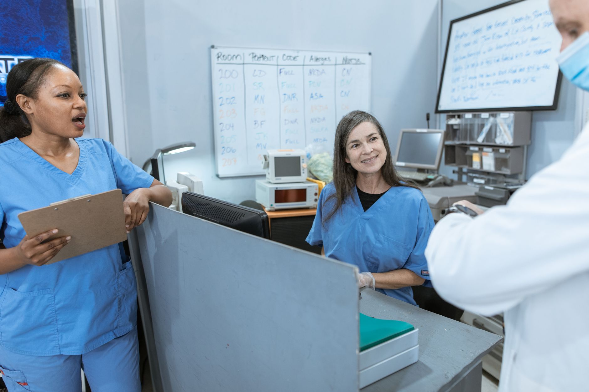 Two healthcare professionals discuss a surgical safety checklist in a hospital setting.