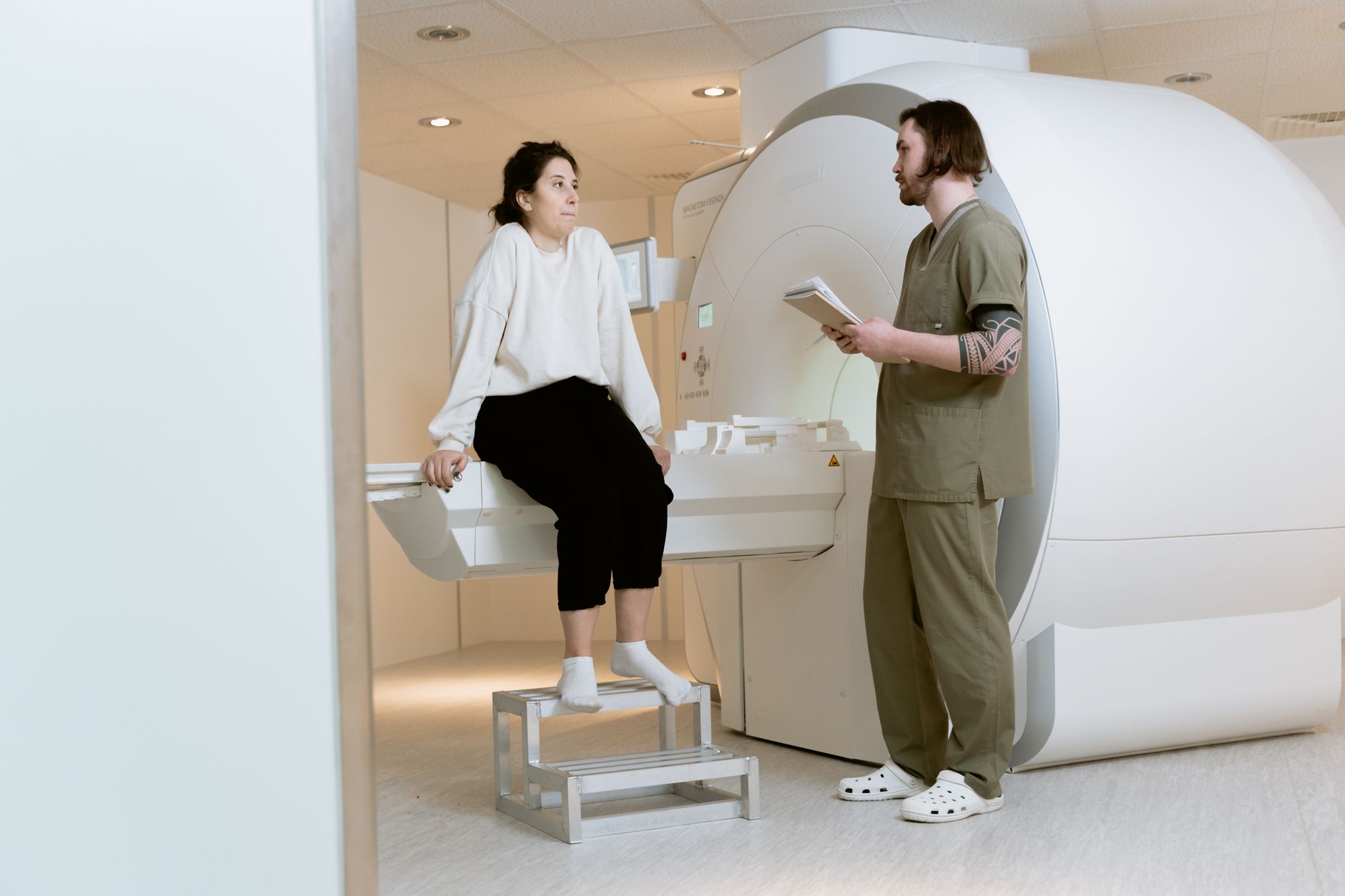 A medical professional reviewing MRI scans with a patient in a Turkish hospital.
