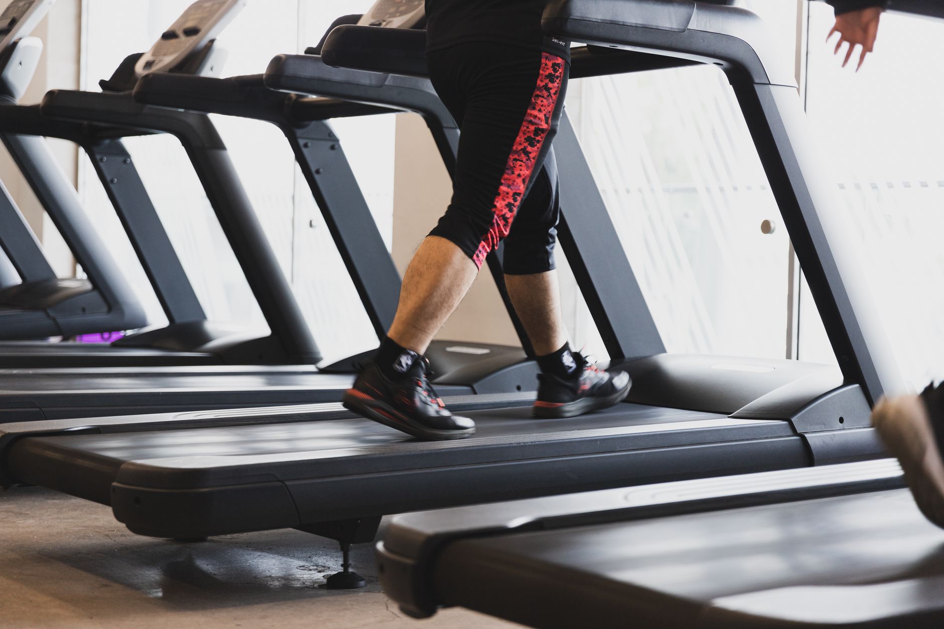 A person walking on a treadmill during a 3D gait analysis session.