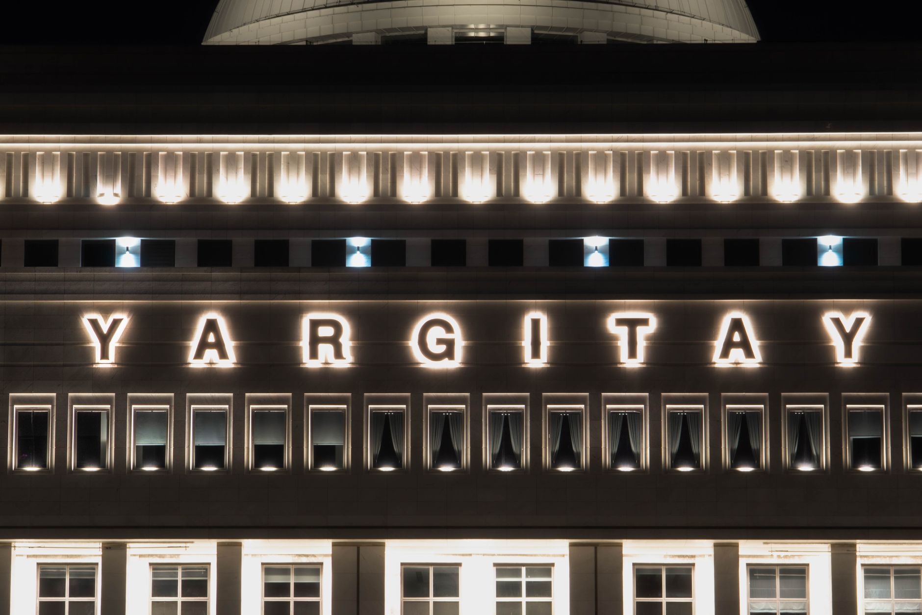 Illuminated facade of the Yargıtay building at night in Ankara.