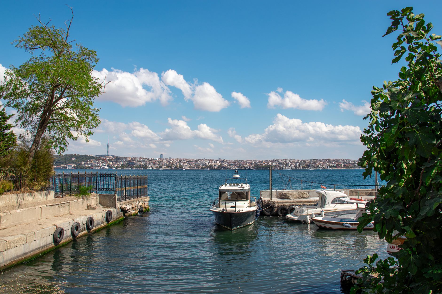 A peaceful scene of the Bosphorus with boats and clouds, reflecting tranquility in Istanbul.