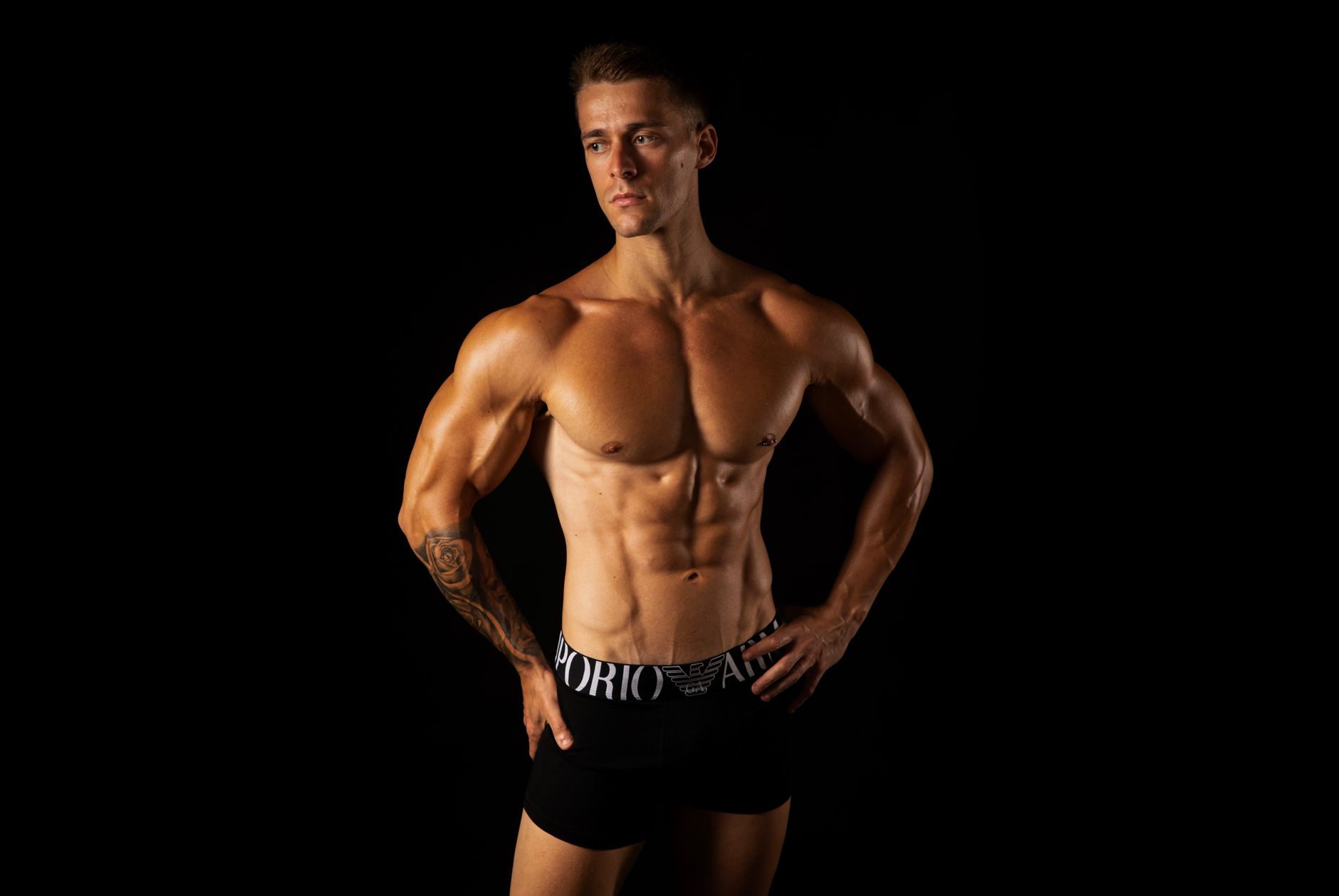 A muscular male torso showcasing the results of body contouring, highlighting defined abs and shoulders.
