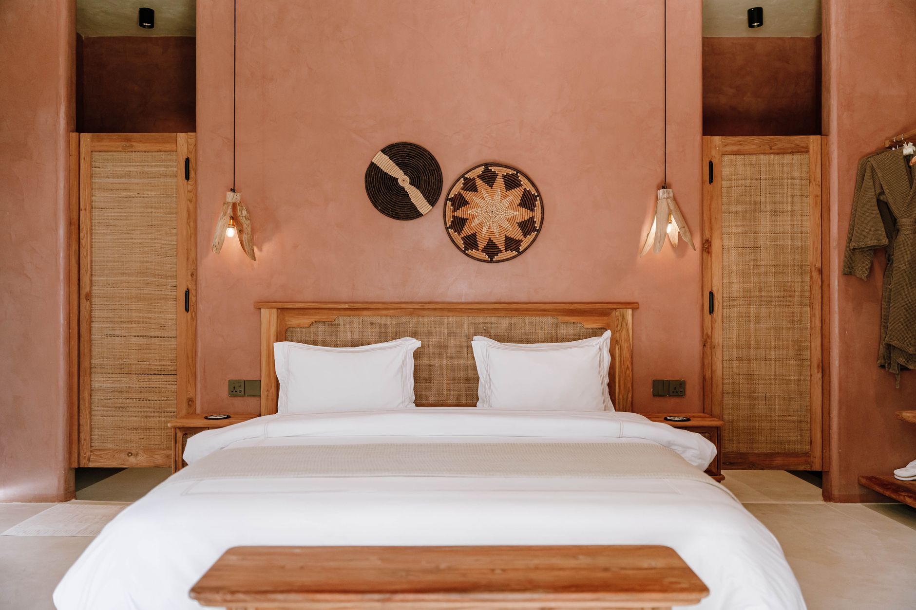 Cozy hotel bedroom featuring earthy tones, natural decor, and sustainable design elements.