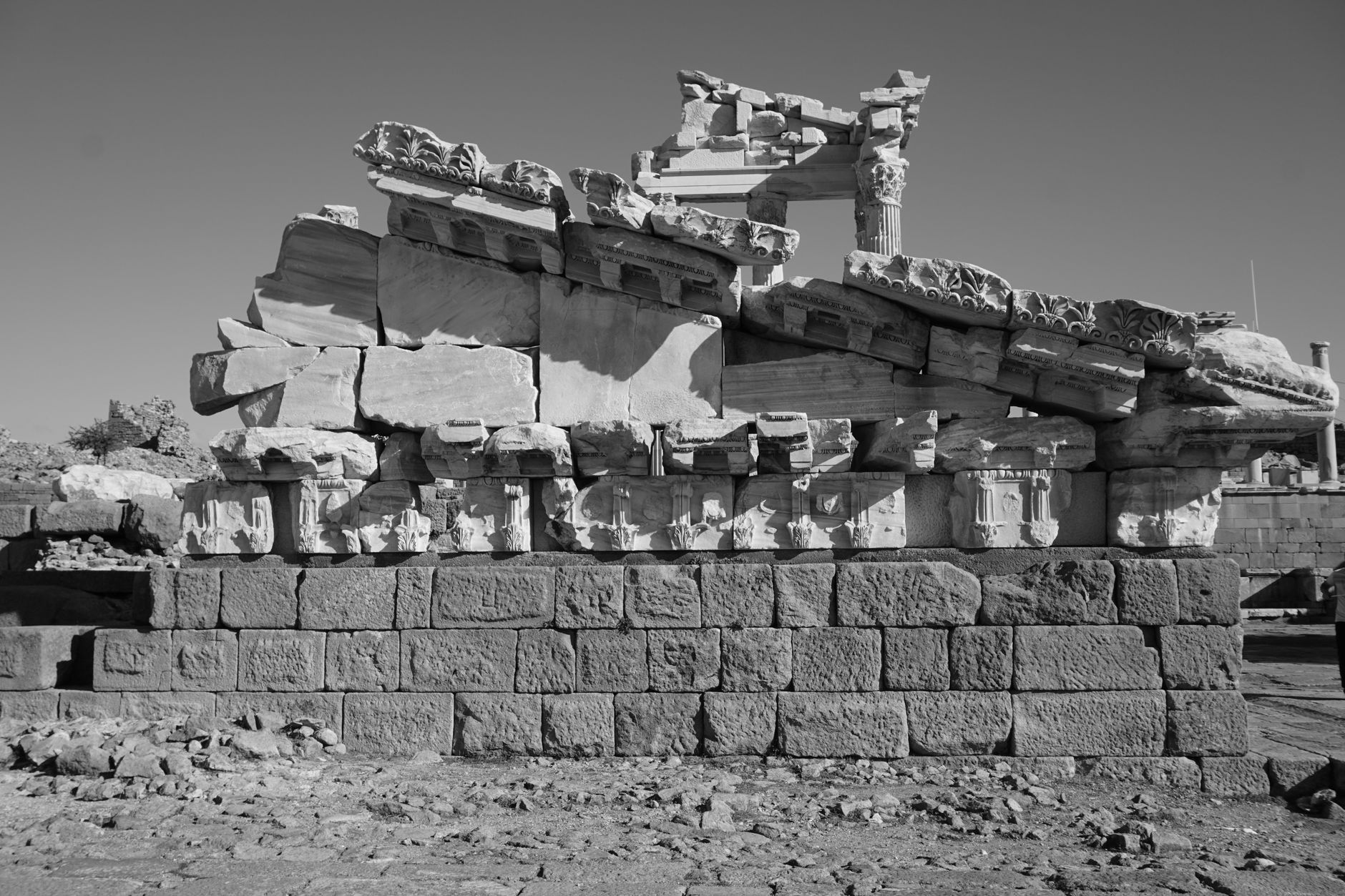 Black and white image of ancient ruins in Anatolia, featuring intricately carved stone structures.