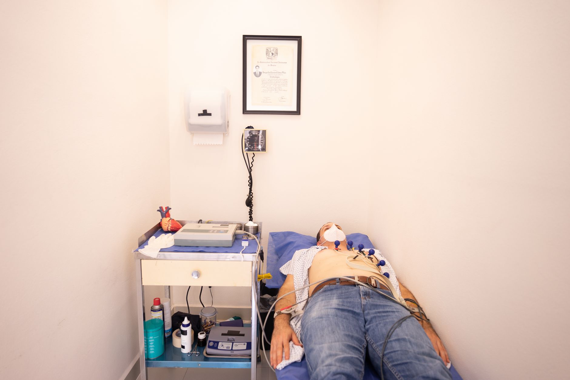 A patient lies on a bed in a clinic during a health examination or analysis.