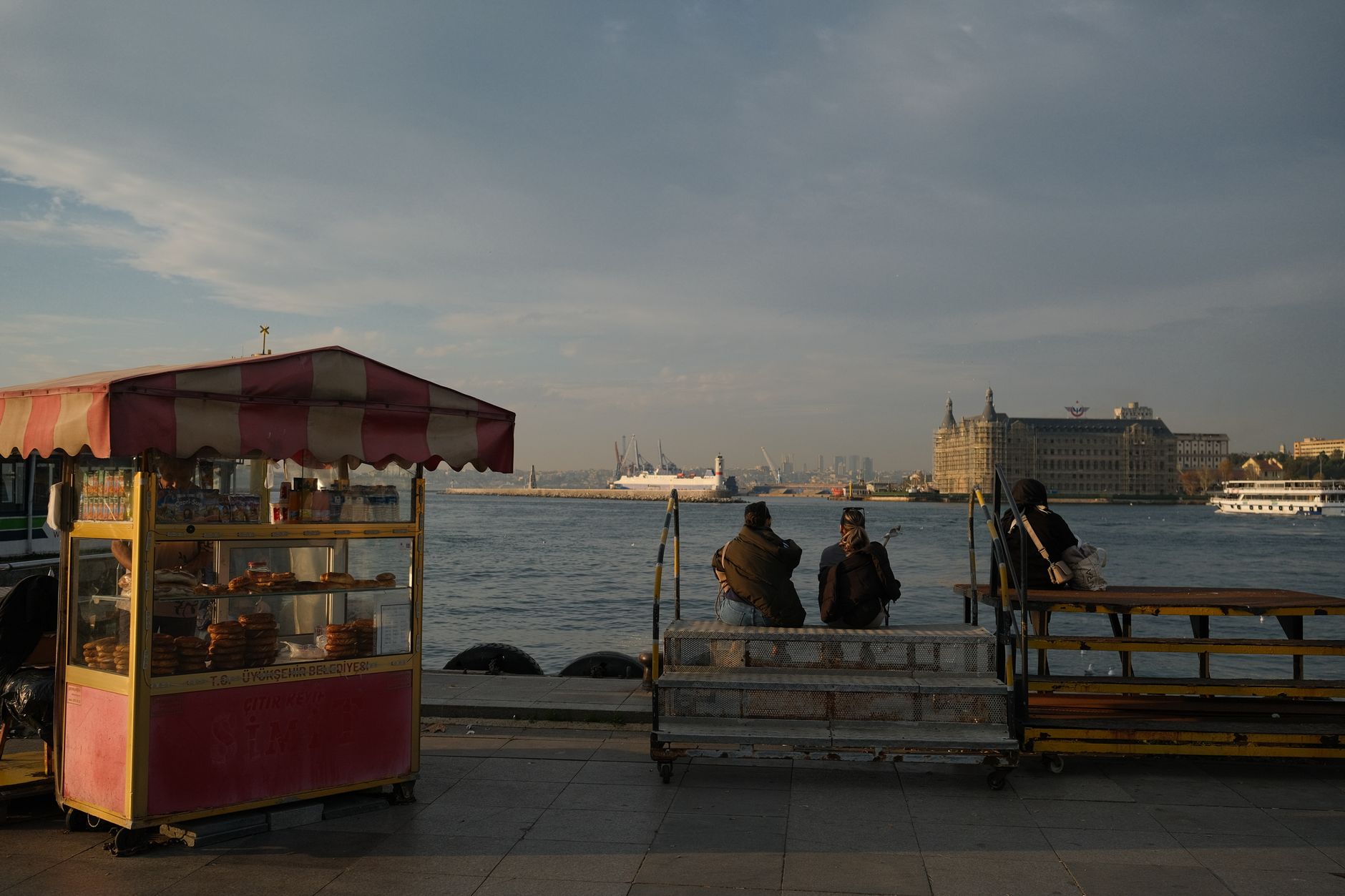 Vapurdaki bir çift simit ve çay eşliğinde Boğaz manzarasının tadını çıkarıyor.