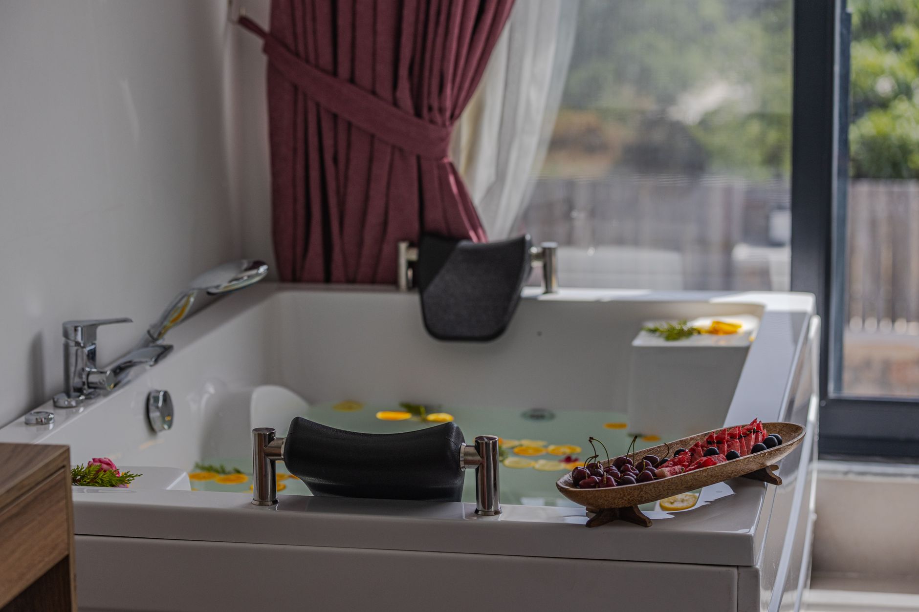 Elegant thermal bath featuring floating flowers, fruits, and a scenic view in Bursa.
