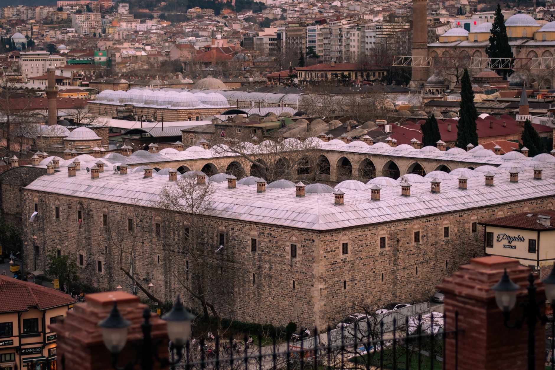 View of a historic Ottoman-style thermal bath with domed roofs in Bursa, showcasing cultural heritage.